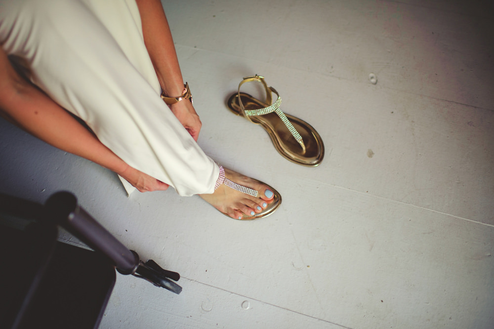 ocean view club wedding : bride putting shoes on