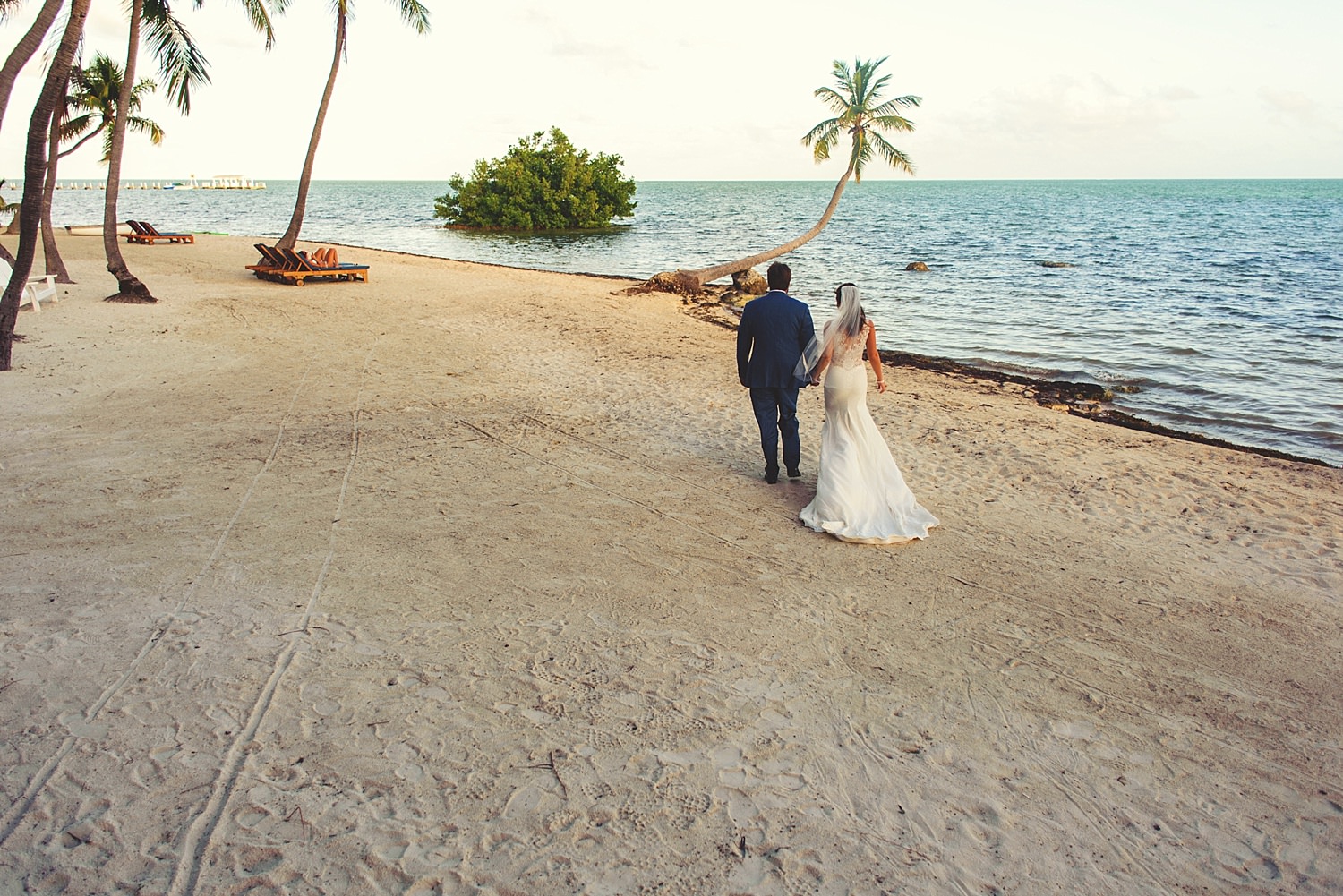 pierre's restaurant wedding: bride and groom walking on beach
