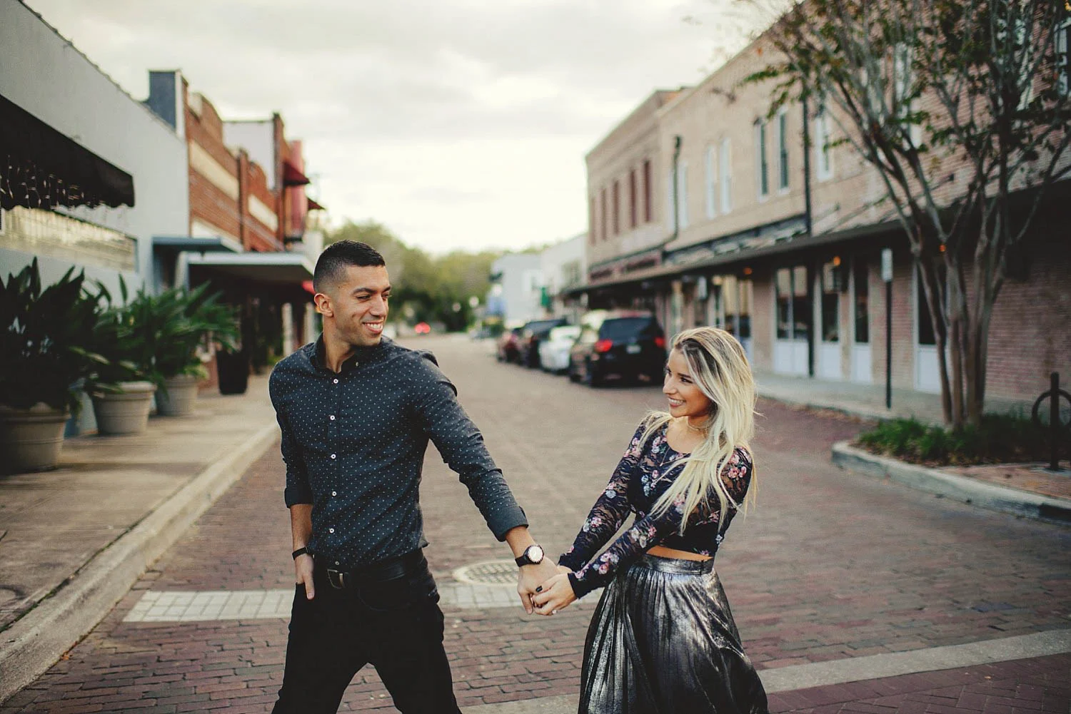 winter garden engagement walking across the street