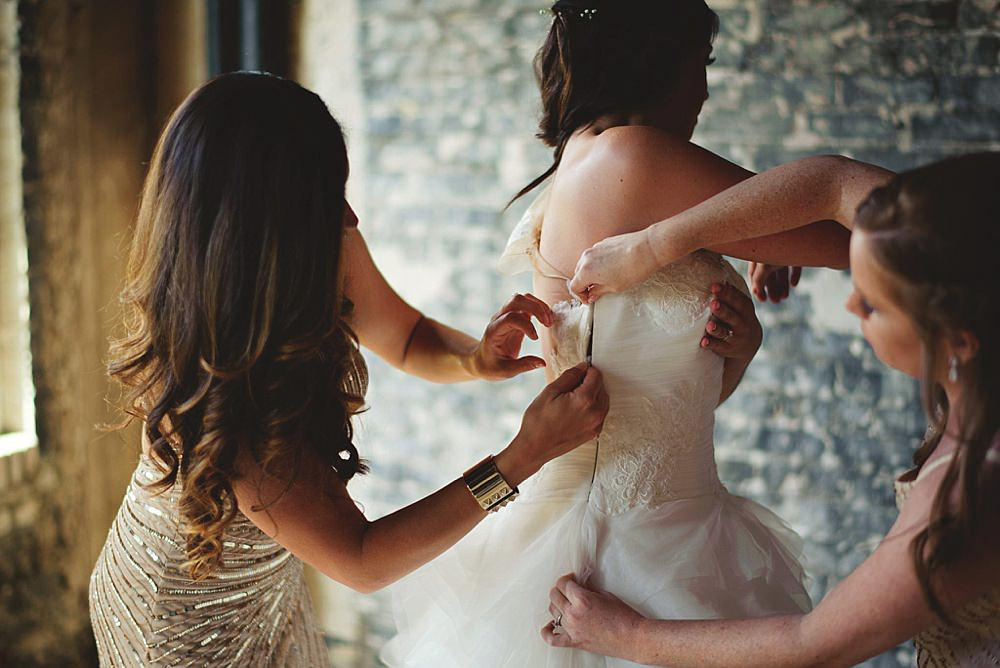 oxford exchange wedding : bride zipping up dress