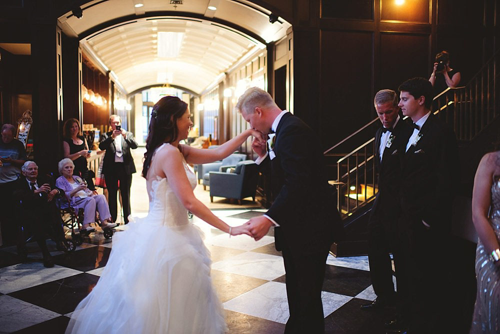 oxford exchange wedding : groom kissing brides hand