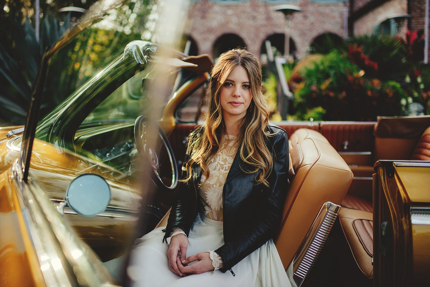 casa feliz wedding photos: bride picture in an old car