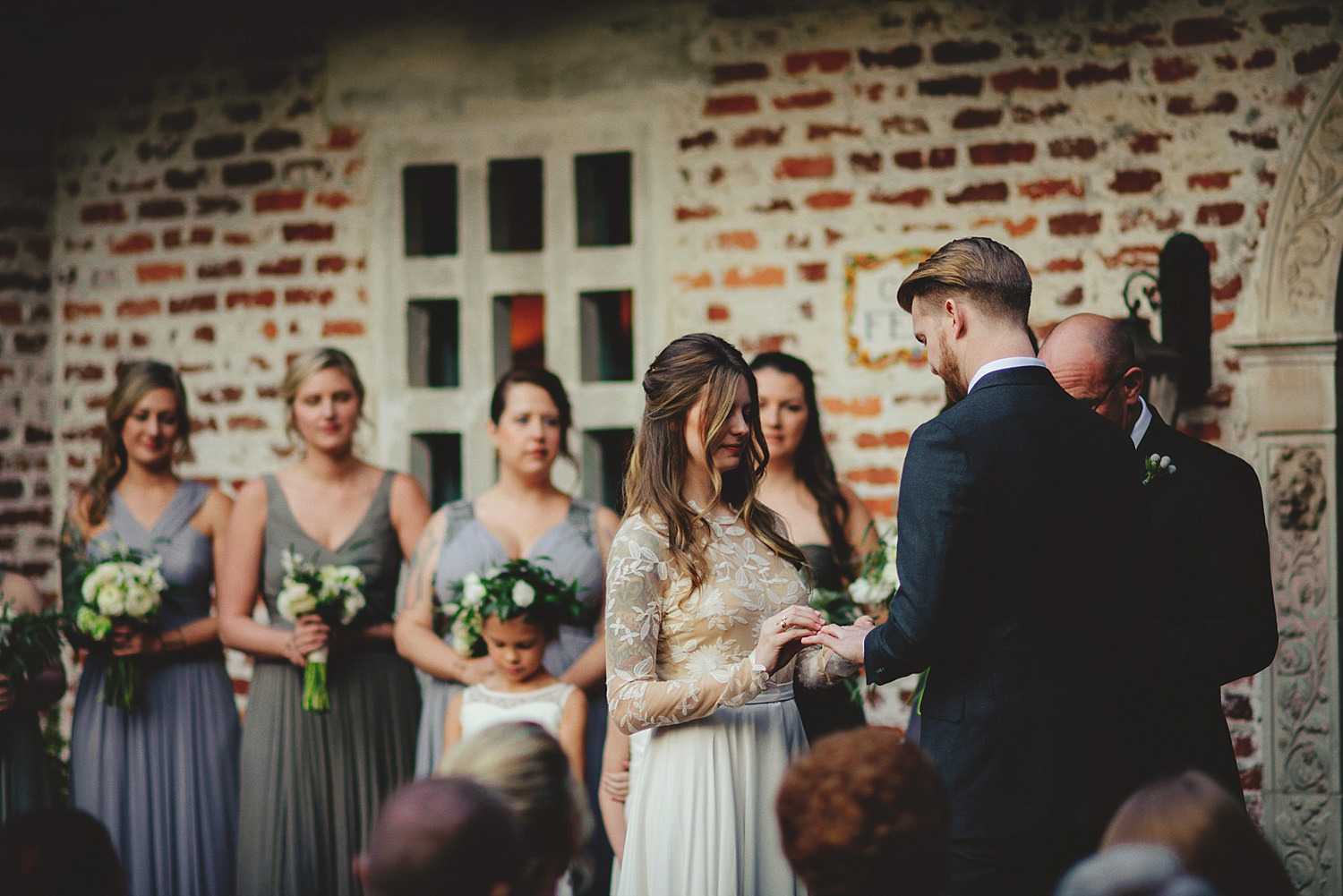 casa feliz wedding photos: bride putting on grooms ring