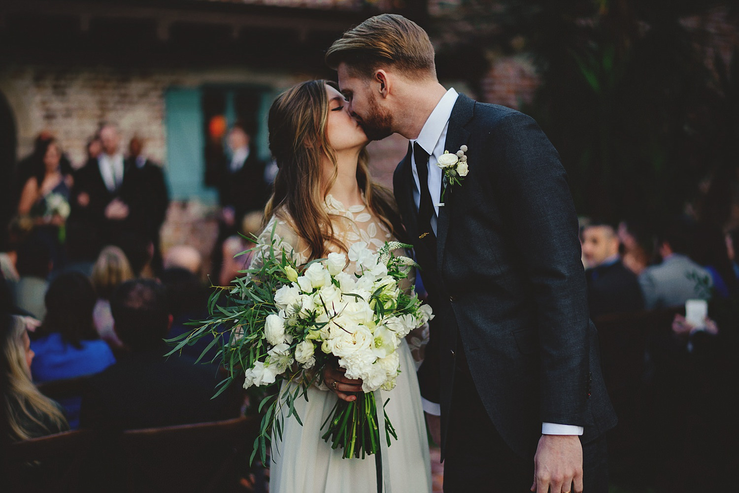 casa feliz wedding photos: kiss at the end of the aisle