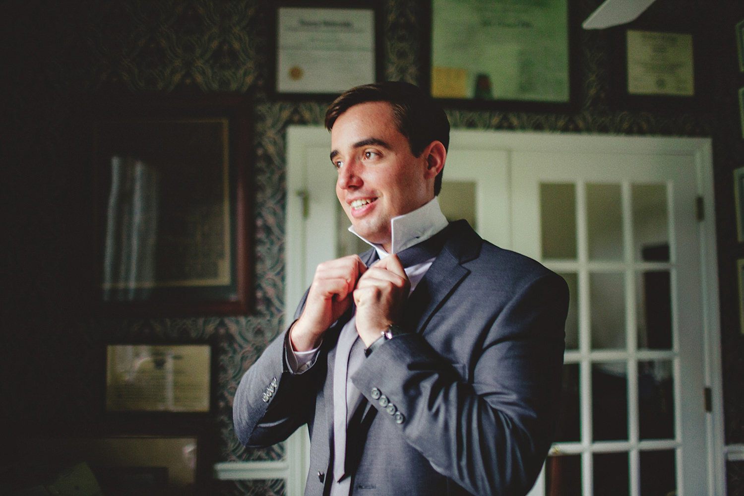 knowles memorial chapel wedding: groom tying tie