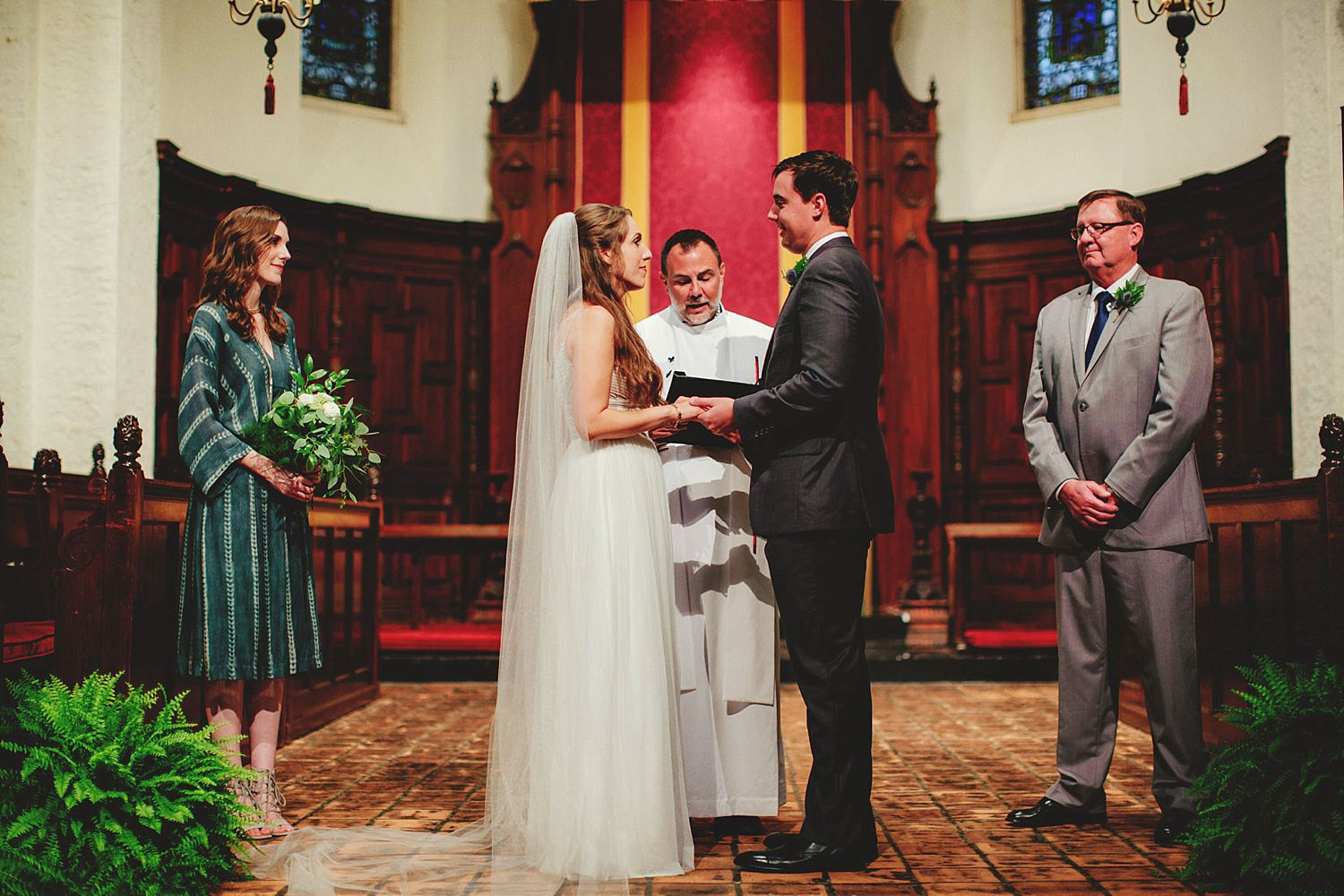 knowles memorial chapel wedding: holding hands in ceremony 