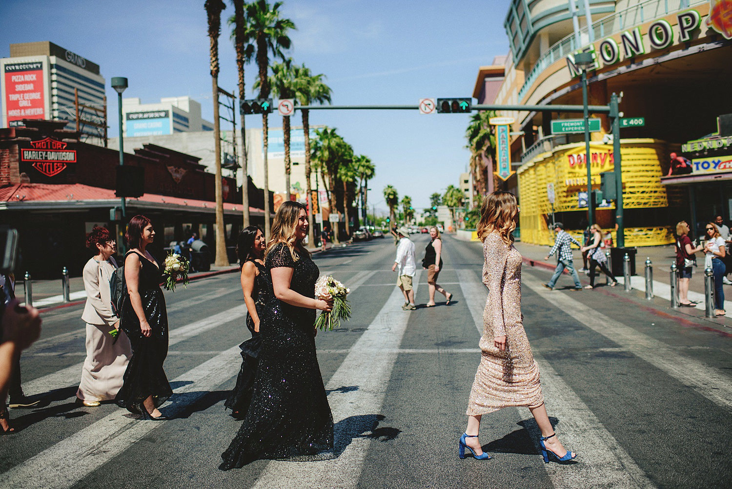 bride and bridemaids walking down old vegas