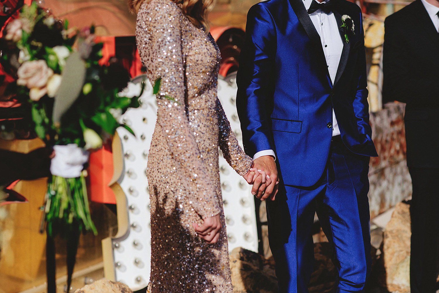 bride and groom holding hands