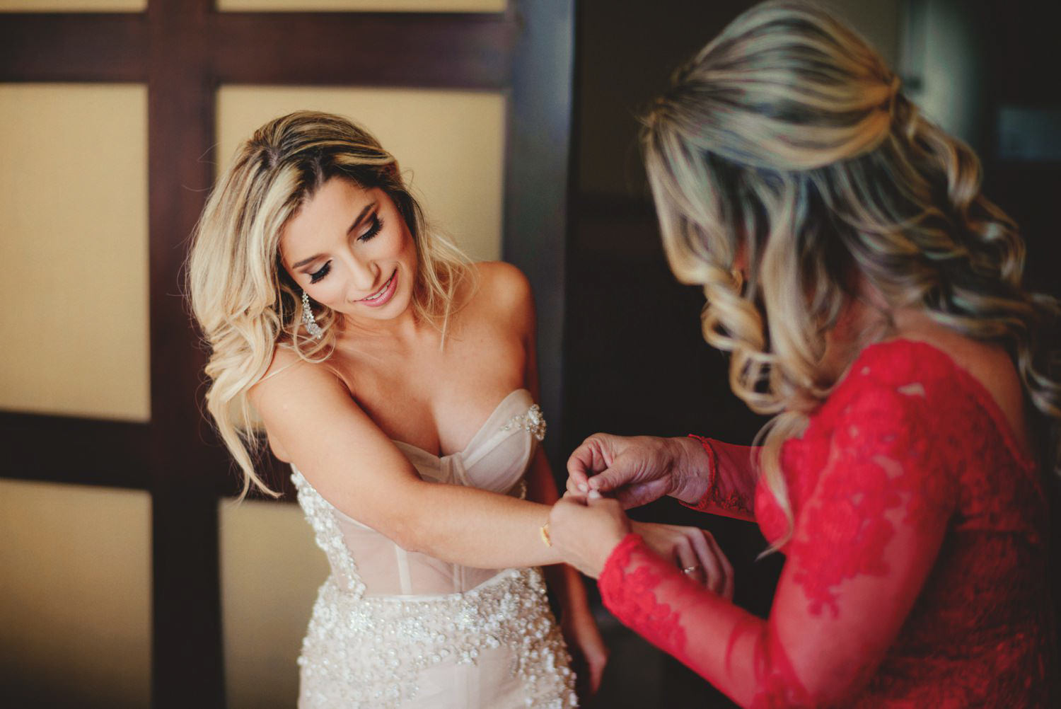 editorial ringling wedding: mother putting in bracelet