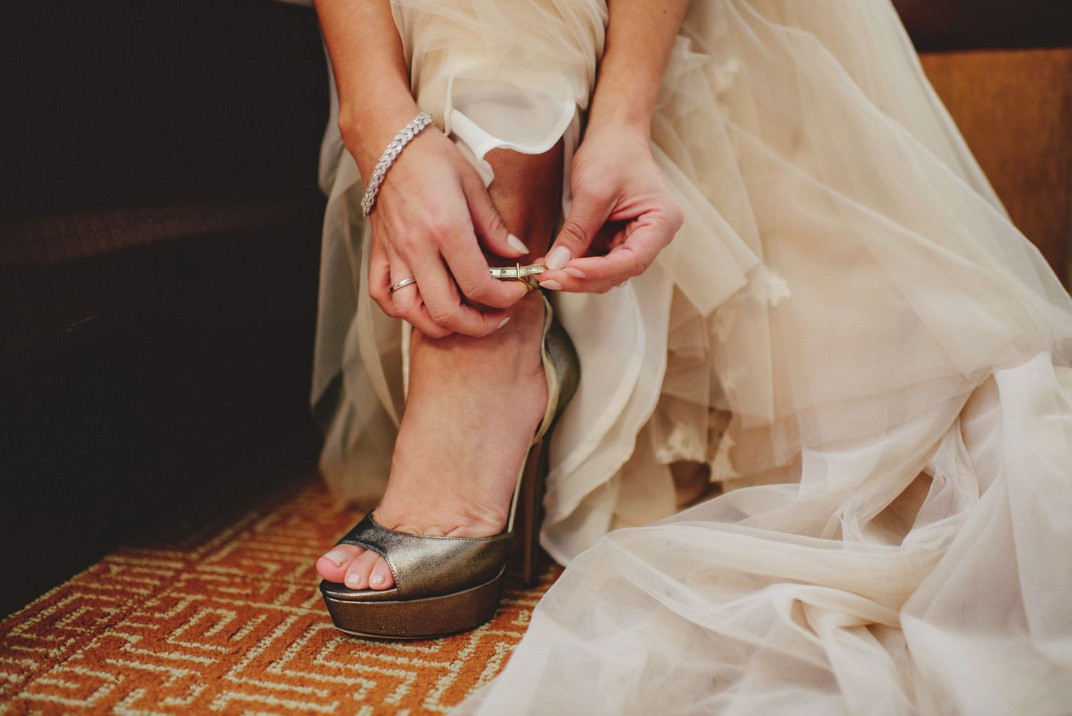 editorial ringling wedding: bride putting on shoes
