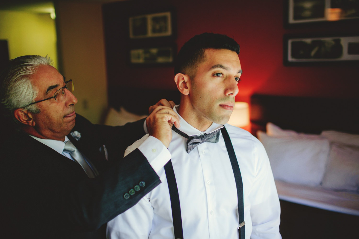 editorial ringling wedding: dad putting on grooms bow tie