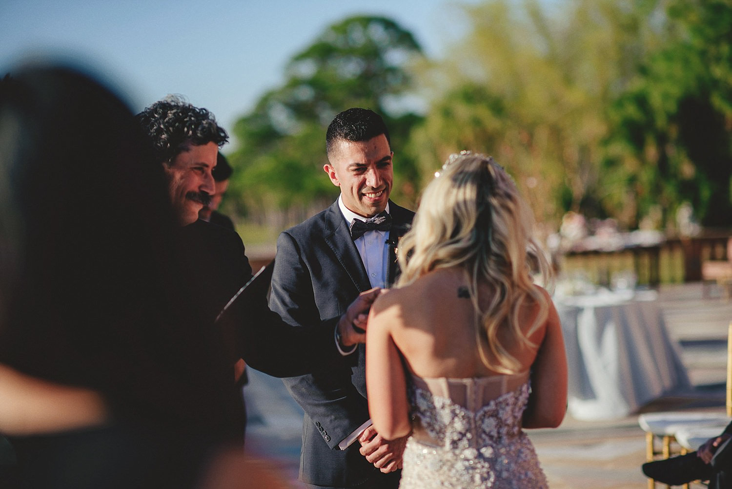 editorial ringling wedding: groom smiling at bride