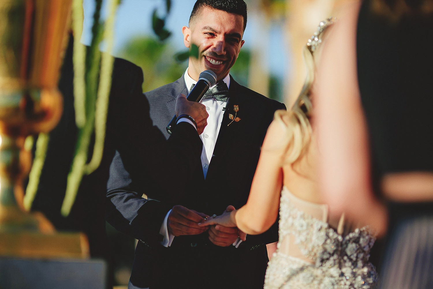 editorial ringling wedding: groom putting on brides ring