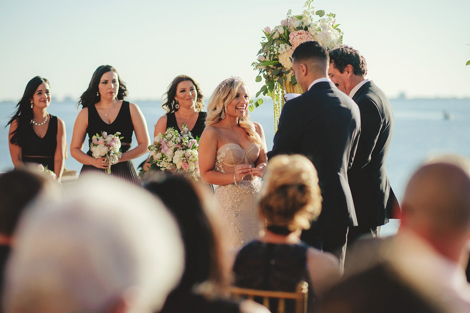 editorial ringling wedding: bride putting on grooms ring