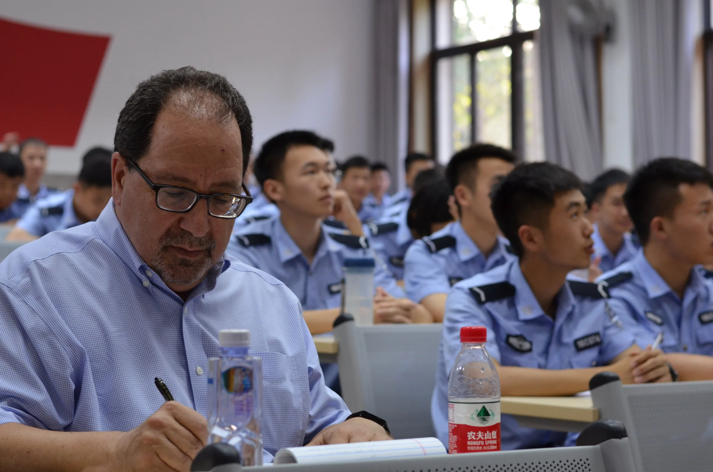 Foreground: Executive Director Ira Belkin Editing with People Public Security University Students in Background