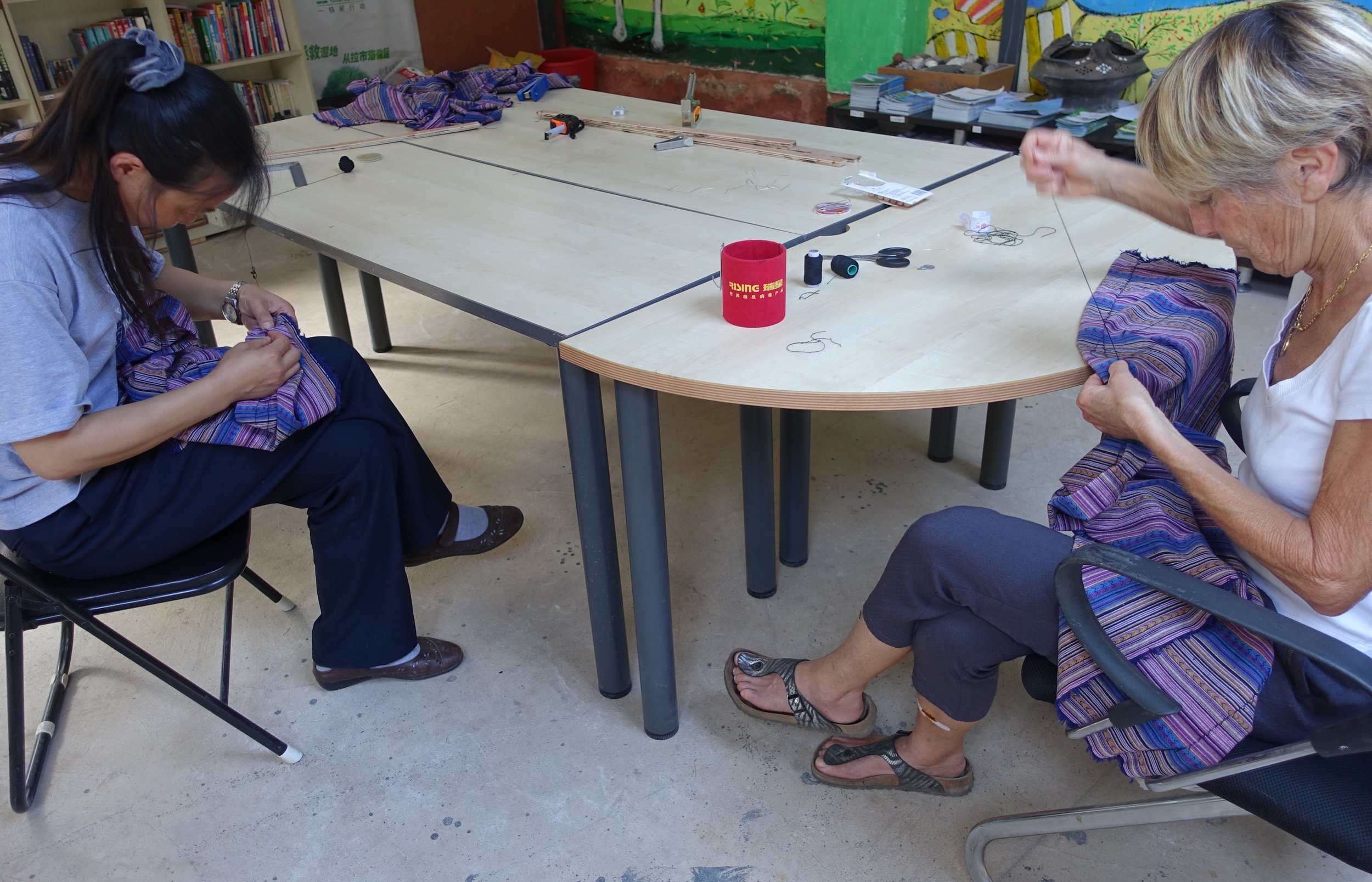 Christine and Miss Yang sewing curtains