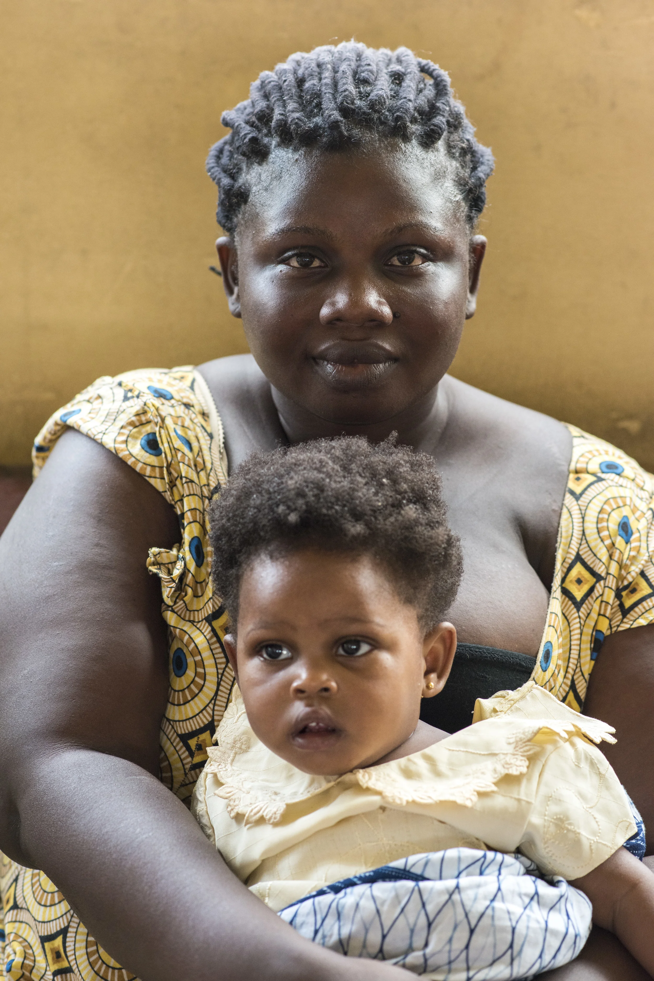  A mother and her child wait inside a midwifery clinic in Ghana’s Volta Region. 