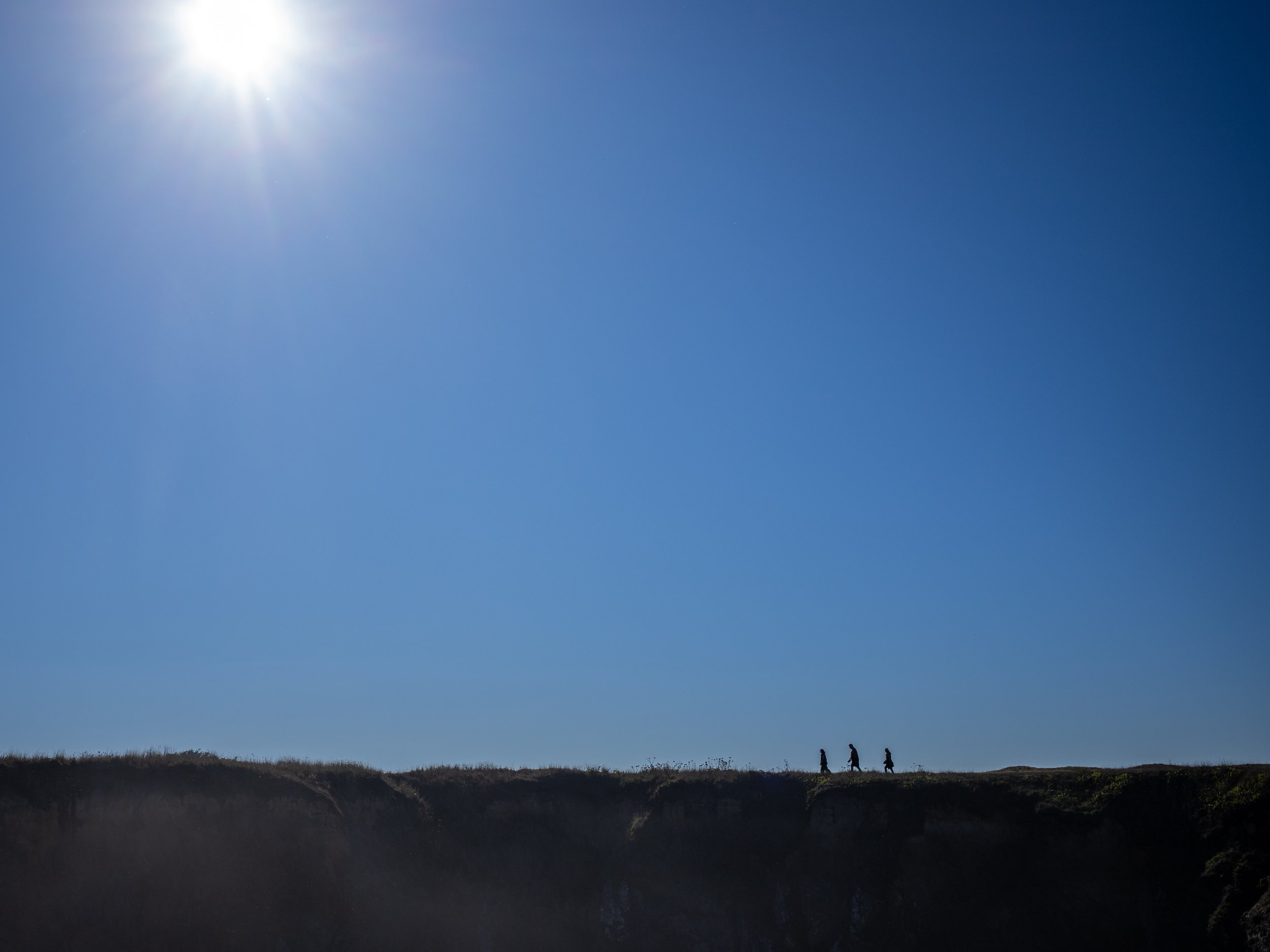  A family walks along a trail at Mendocino Headlands State Park in Northern California. 