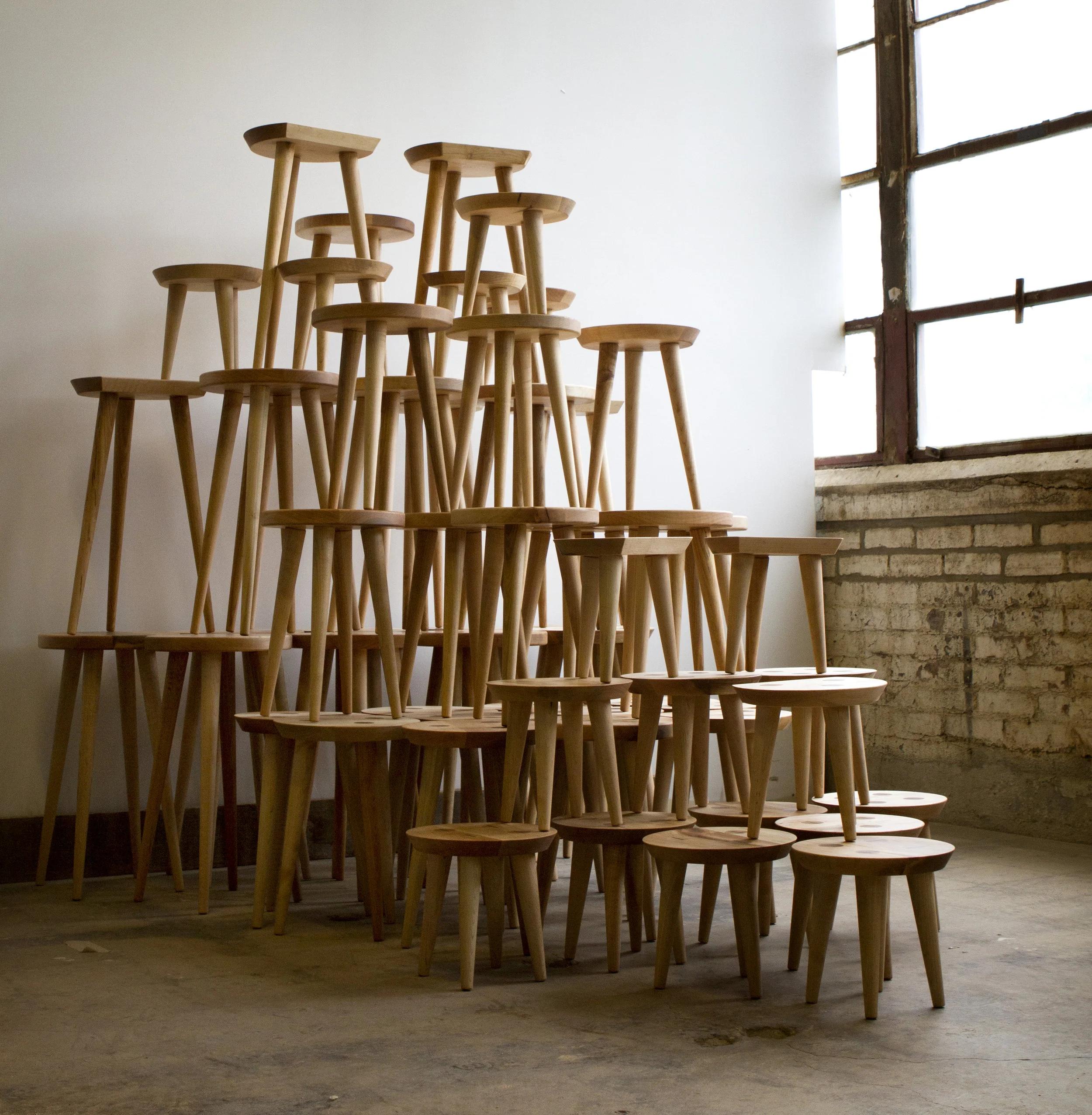 Stack of custom designed Shaker-style maple display stools with wedged through tenon legs.