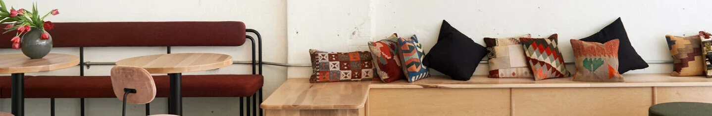 Custom designed steel tube banquette with upholstered seat and back, maple bench banquette seating.