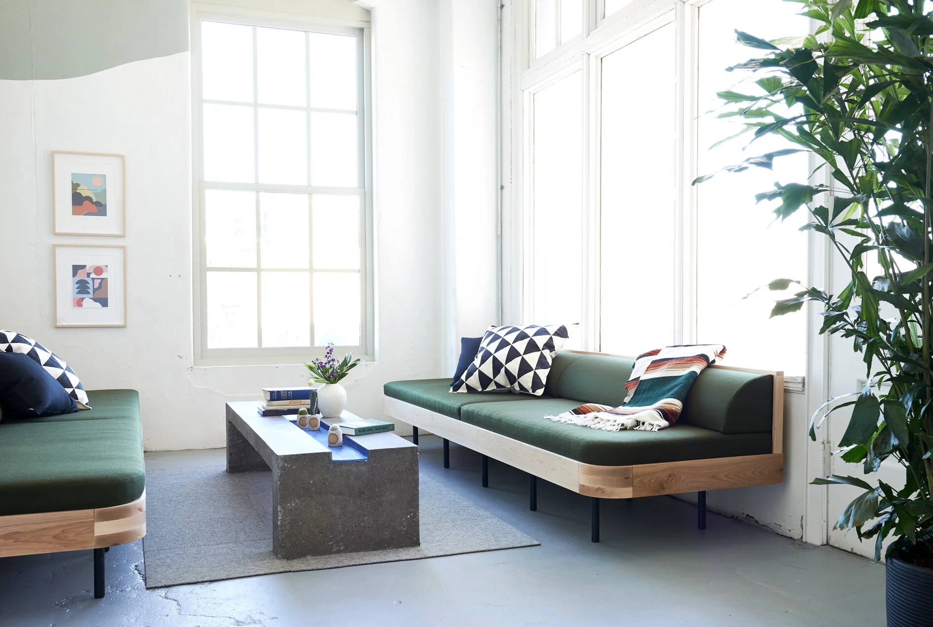 Custom designed sofas, couches with upholstered seats and backrests, steel tube legs, and maple trim.