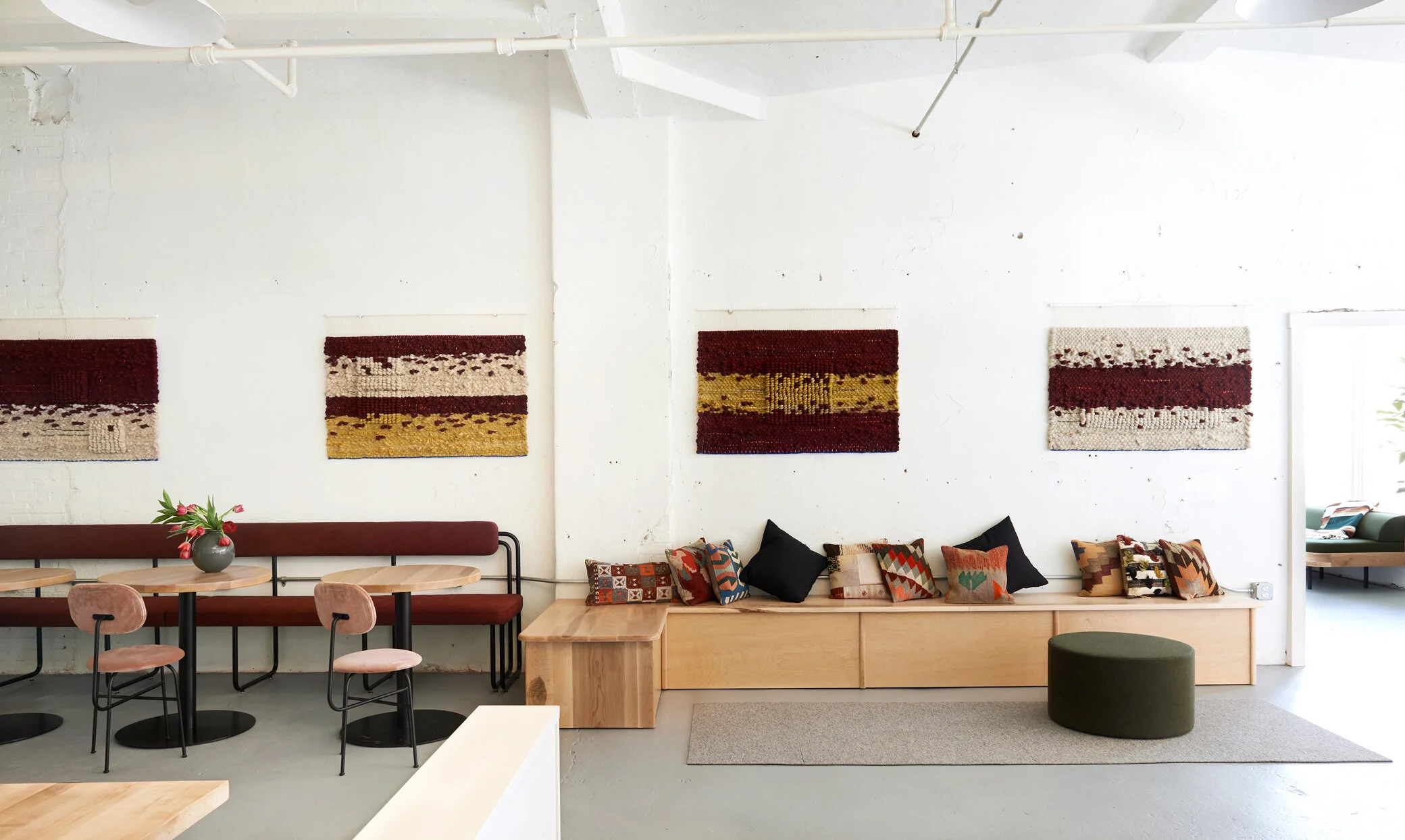 Custom designed steel tube banquette with upholstered seat and back, maple bench banquette seating.