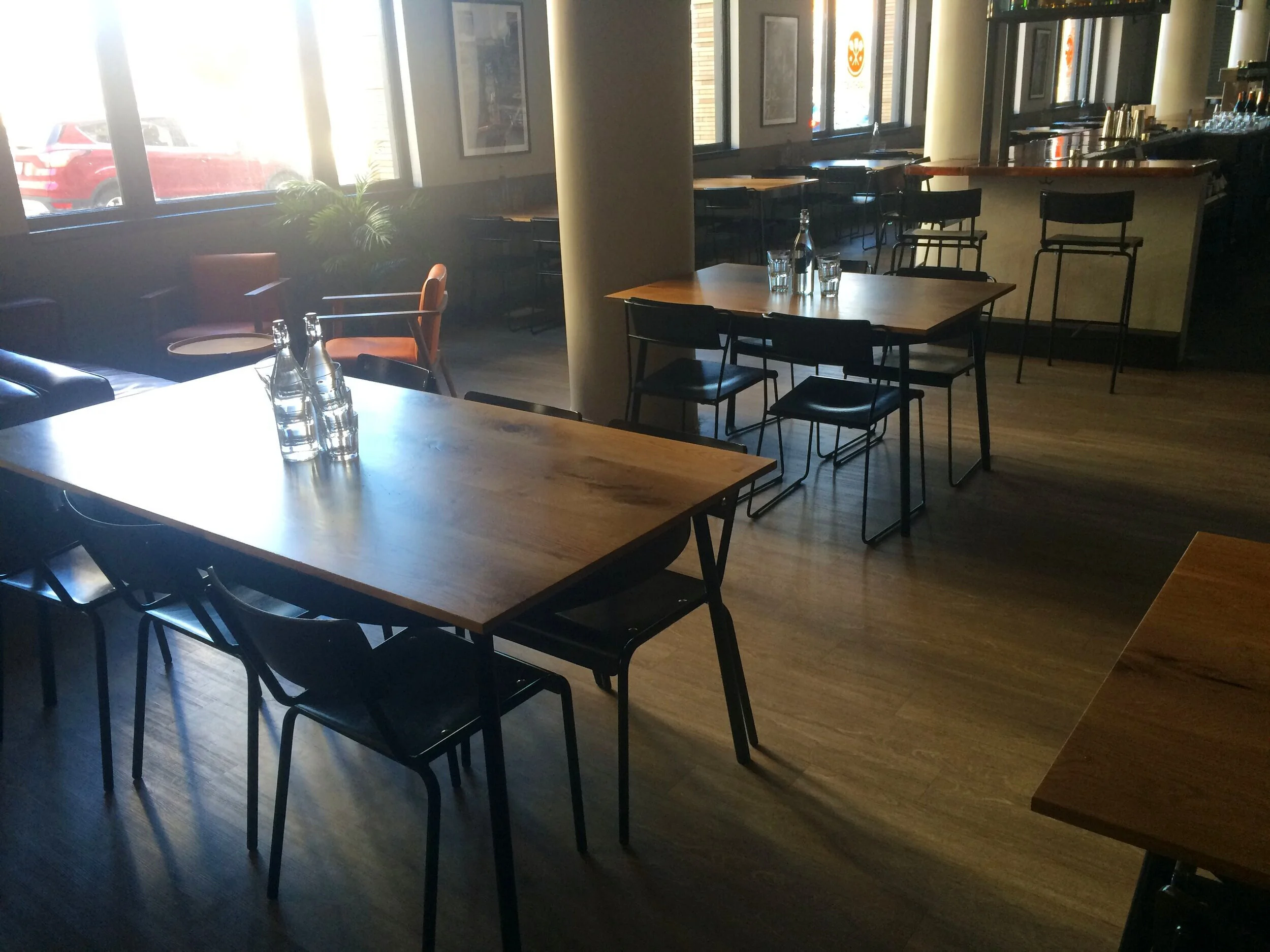 Custom designed white oak and steel dining tables.