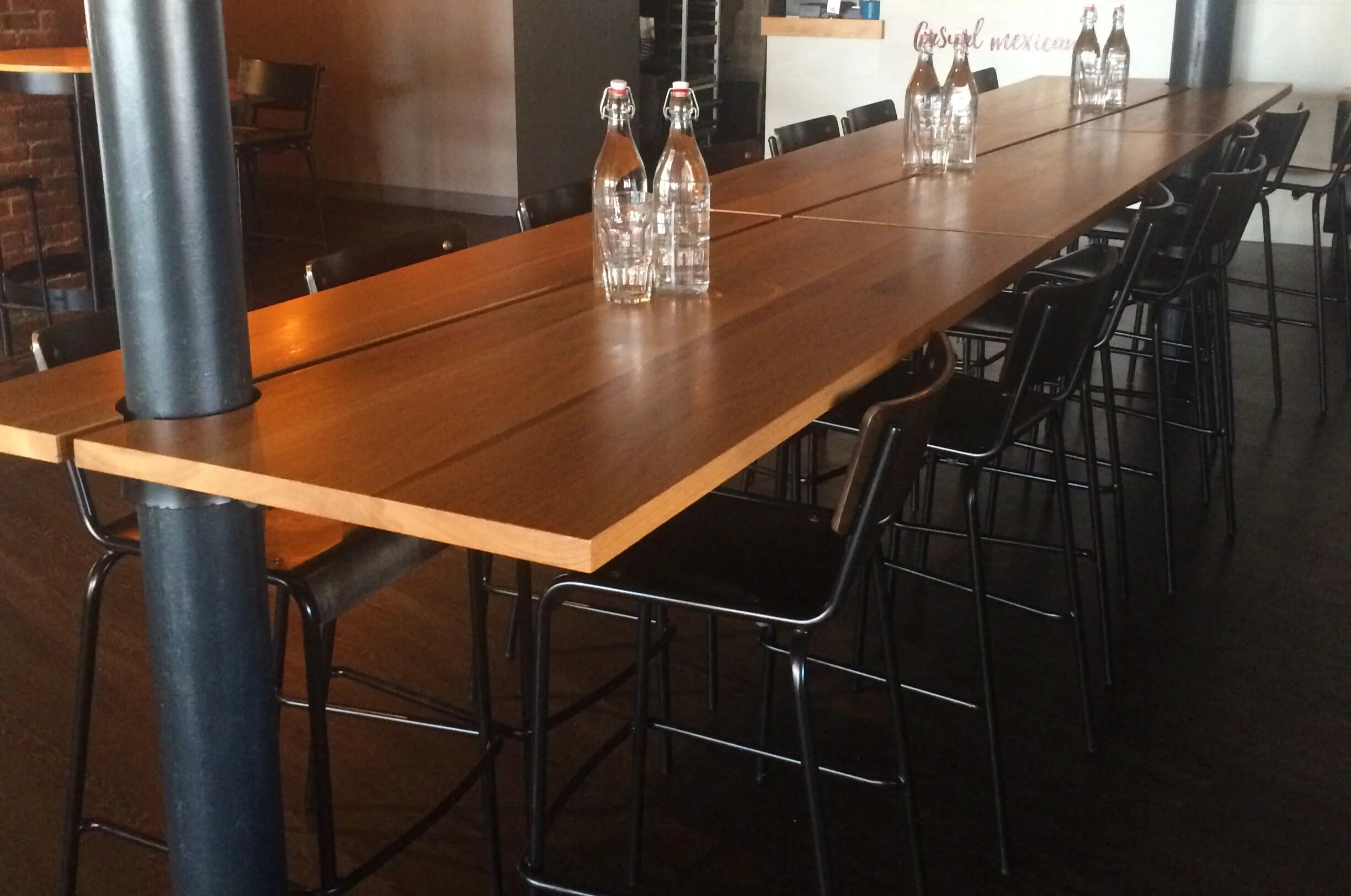 Custom designed floating white oak and steel communal dining table.