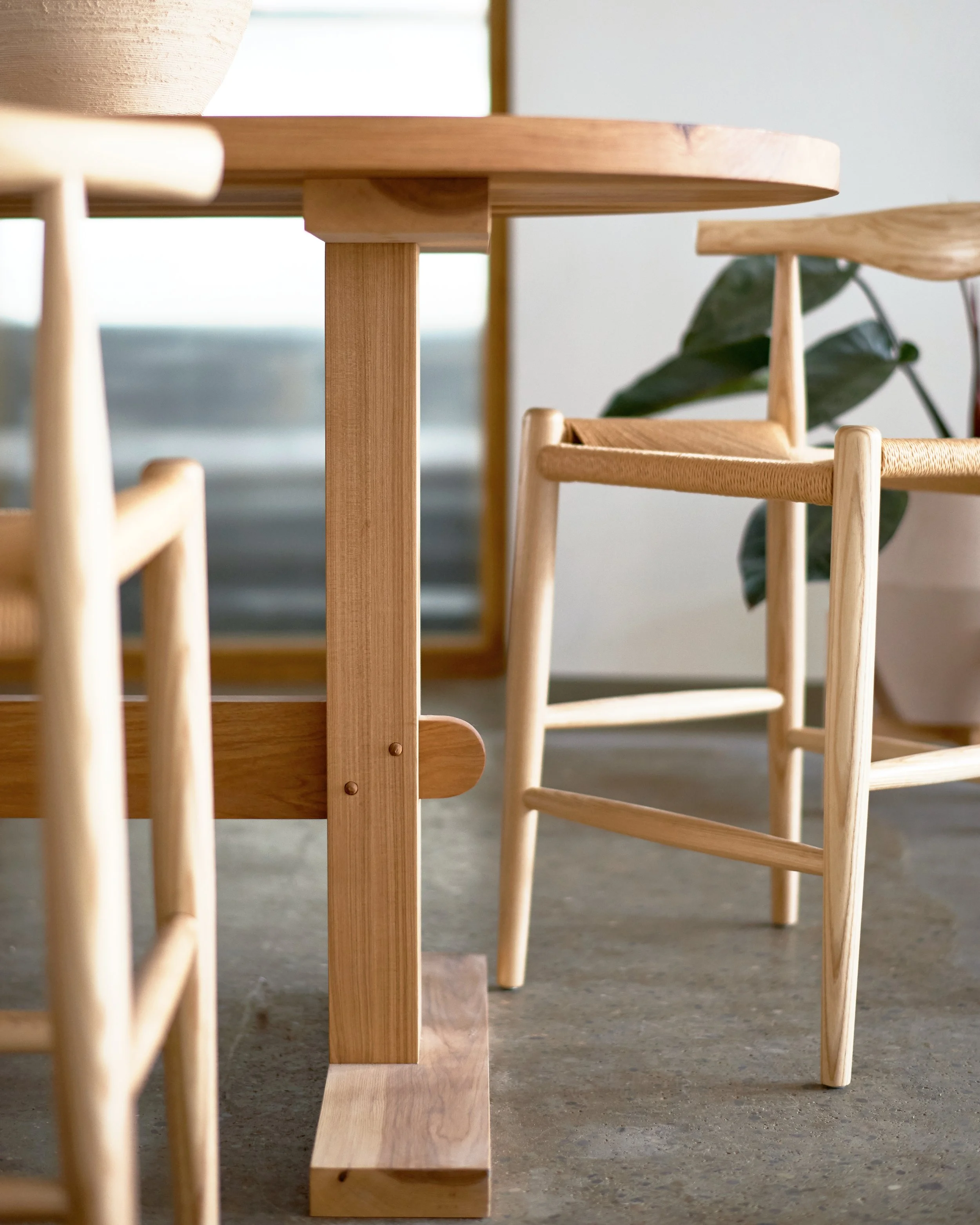 Custom designed high top hickory communal dining table with trestle base; doweled through tenon detail.