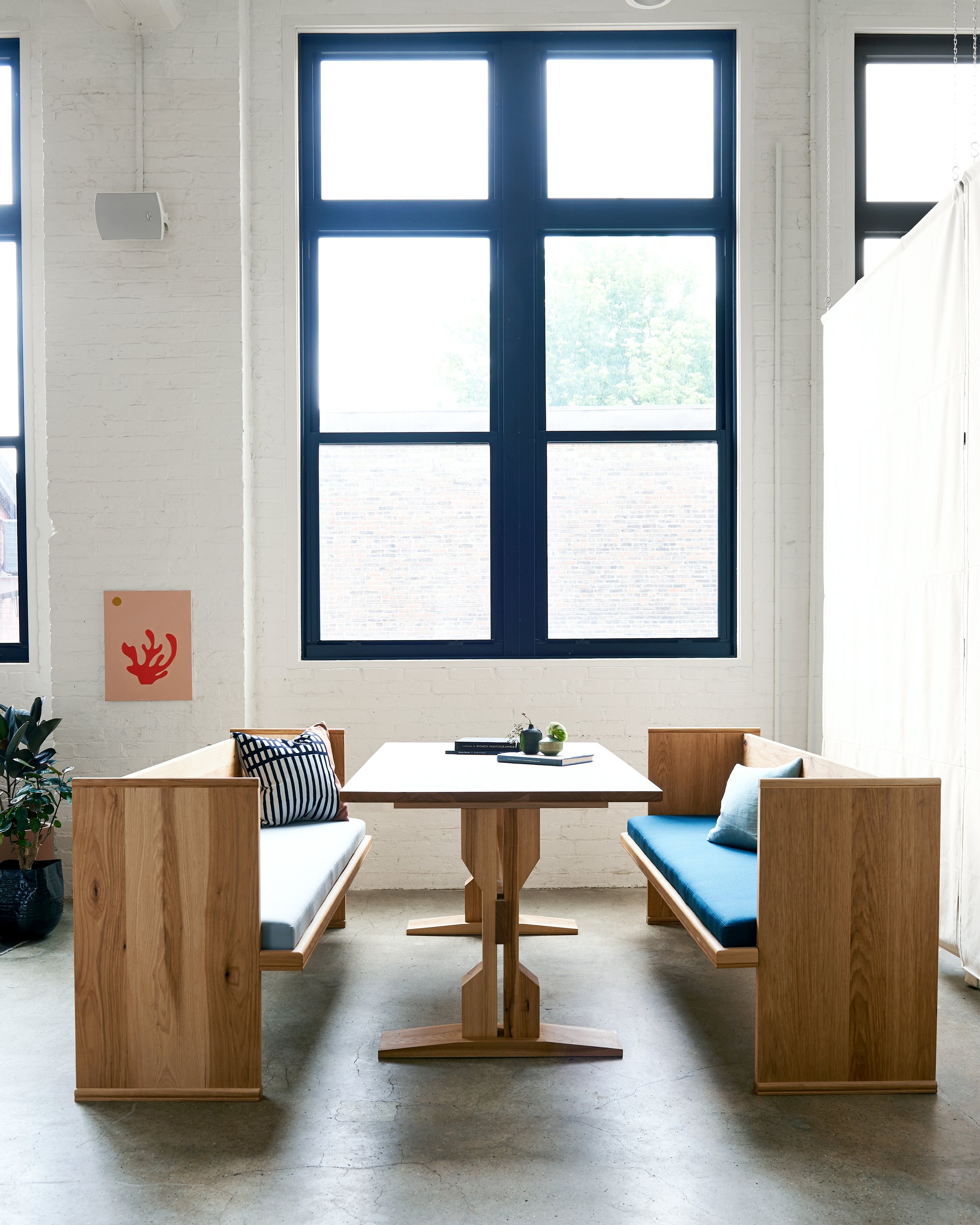 Custom hickory pew benches with upholstered seats; custom designed hickory work table with trestle base.