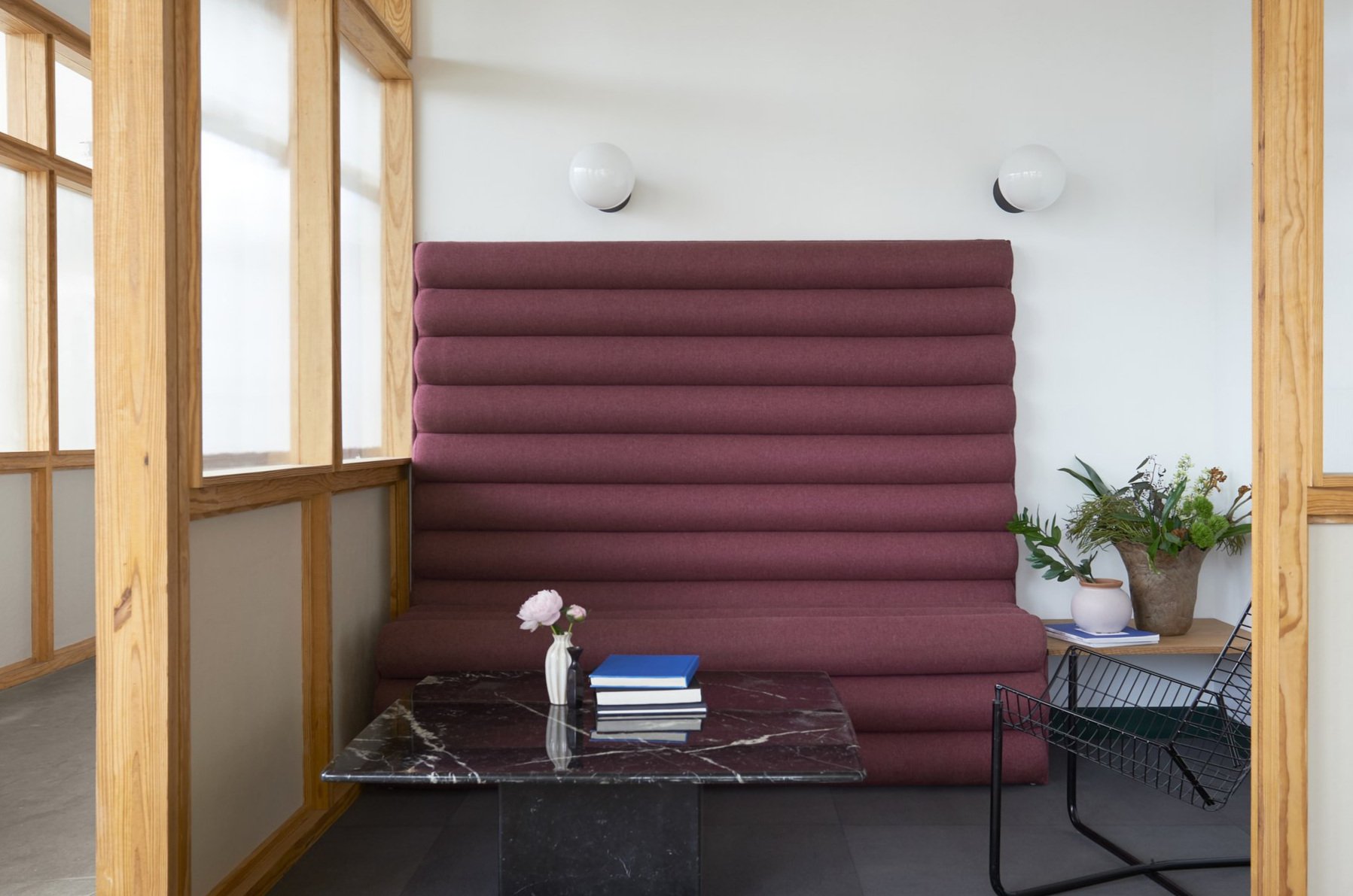 Custom channel upholstered banquette seating with white oak side table.