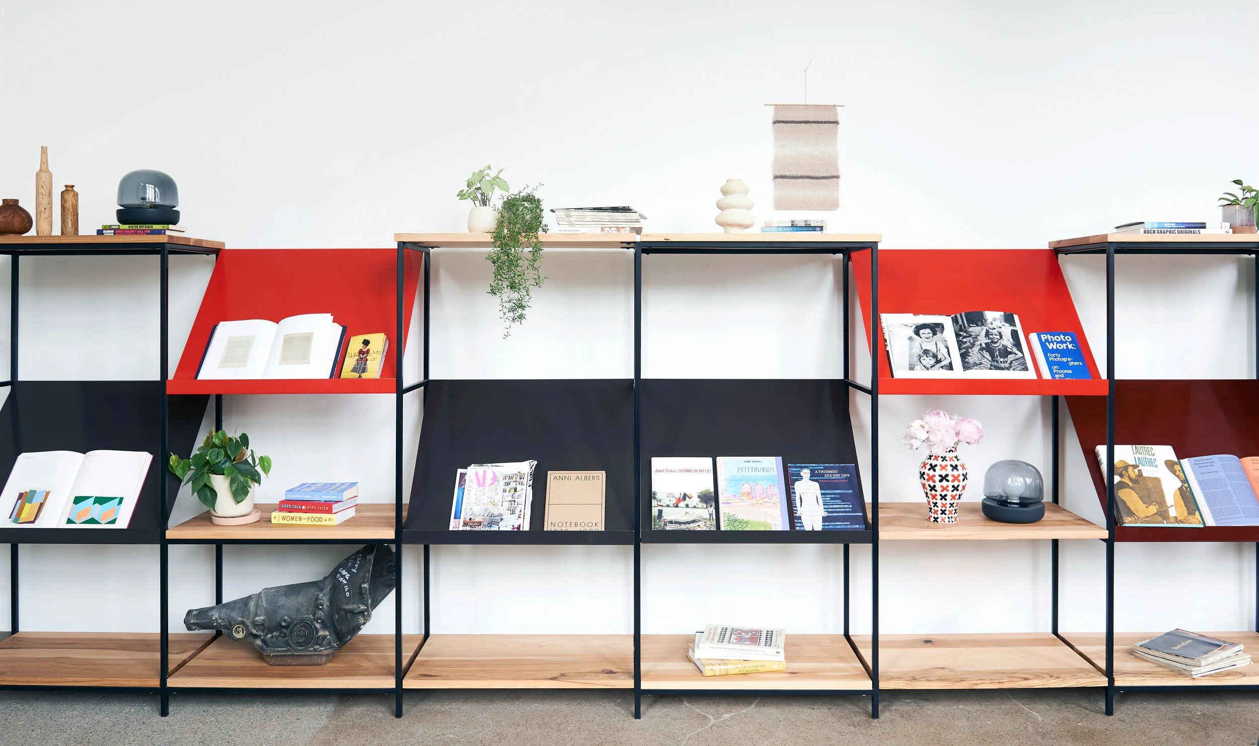 Custom bookcase/display unit with hickory shelves, tube steel frame, and sheet steel display boards.