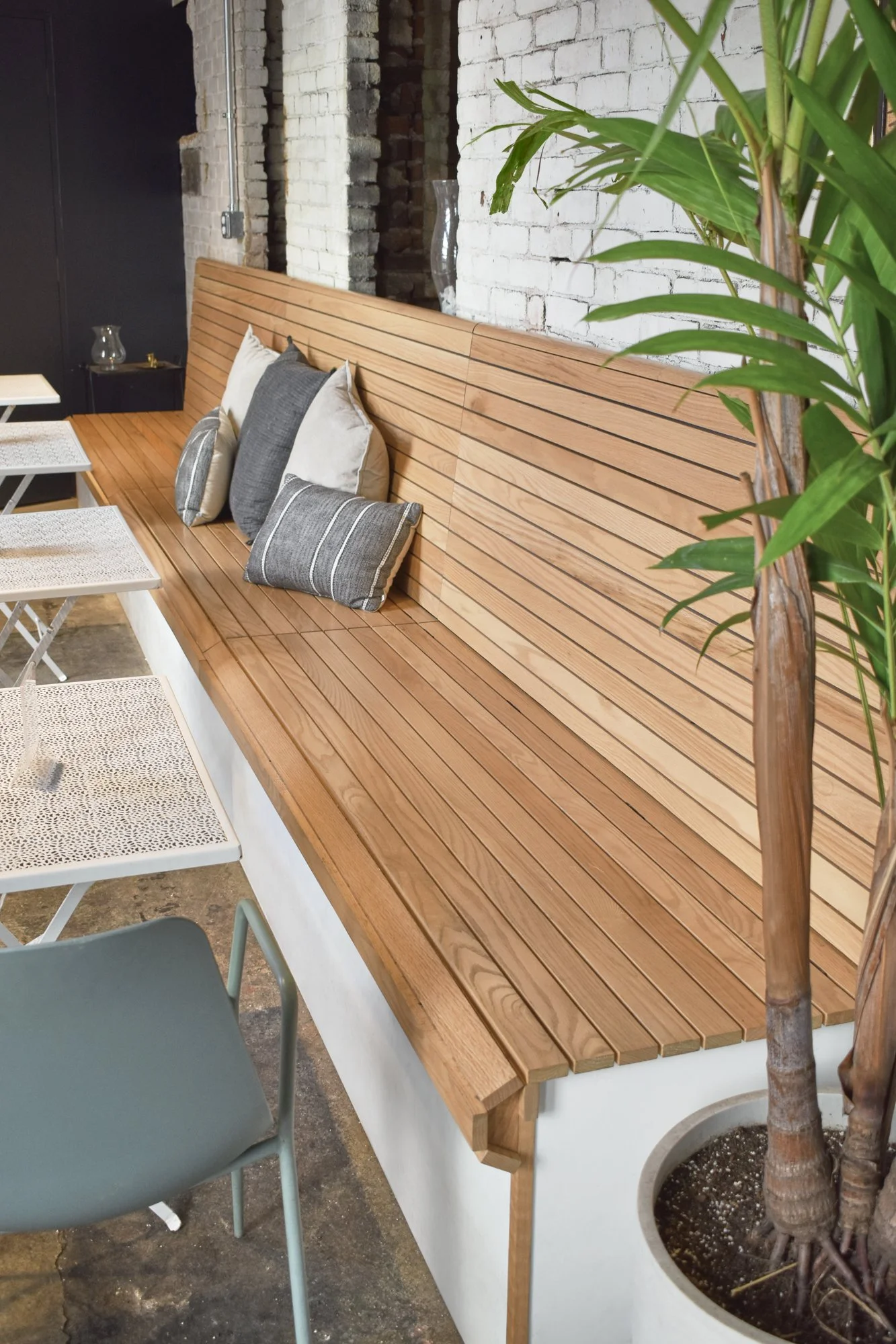 Custom red oak banquette seating with integrated storage.