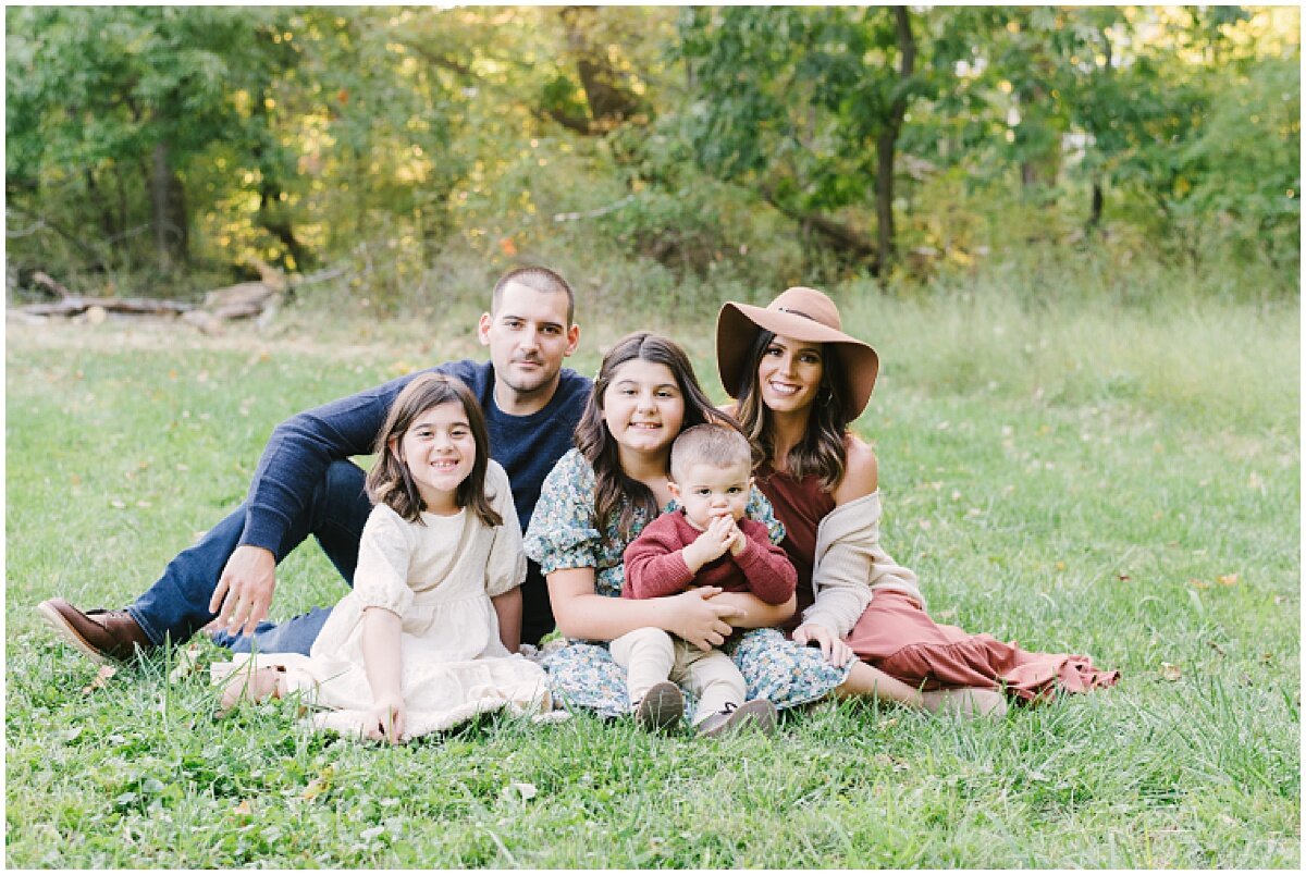  Family of five portrait outside on grass 