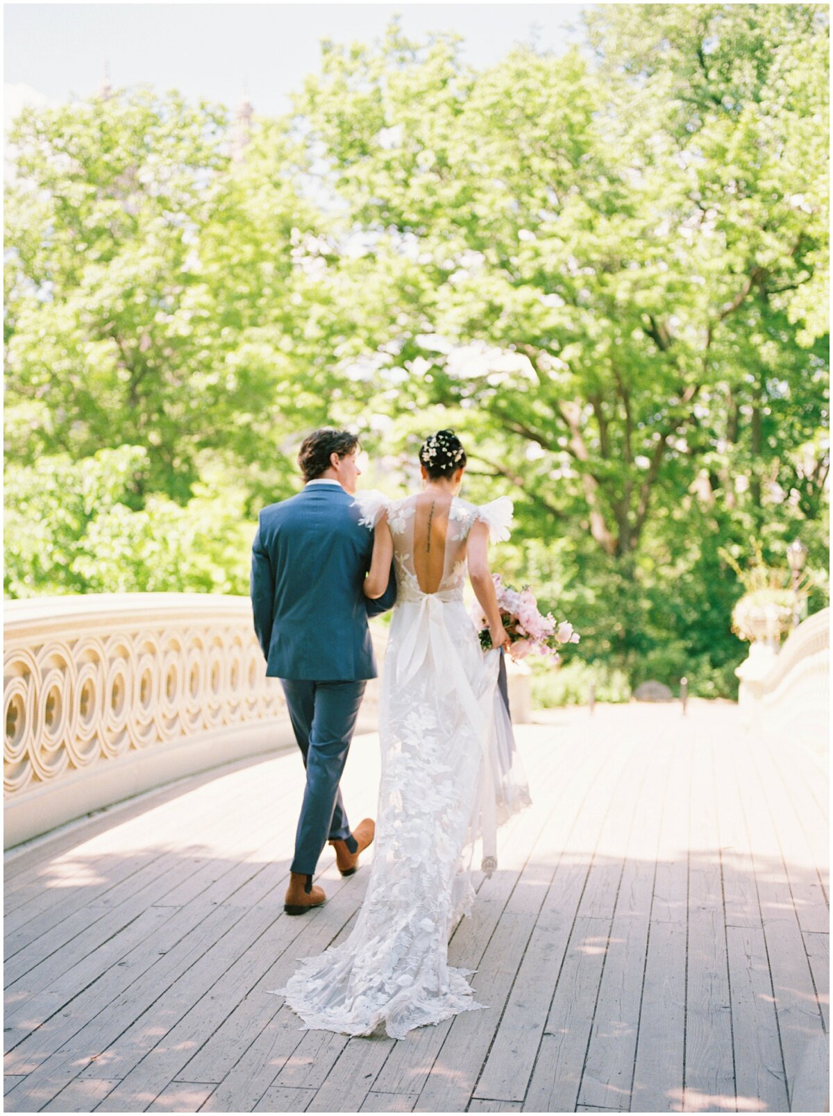  bride and groom walking in central park 