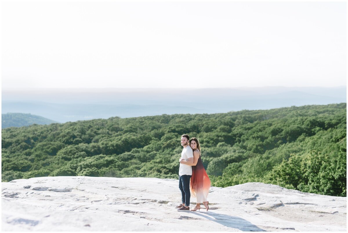 Woman wrapping arms around man during Minnewaska State Park engagement session | NKB Photo