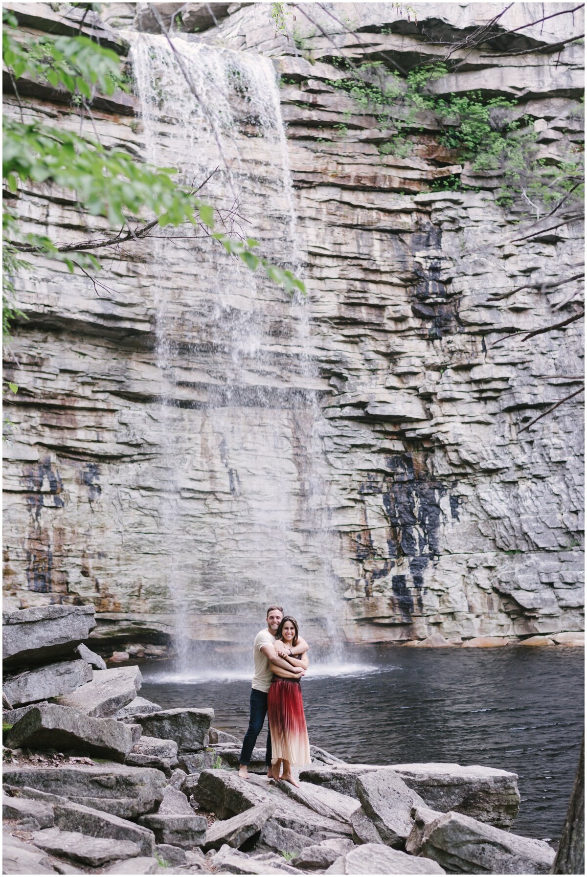 Couple standing in front of waterfall during Minnewaska State Park Engagement Session | NKB Photo