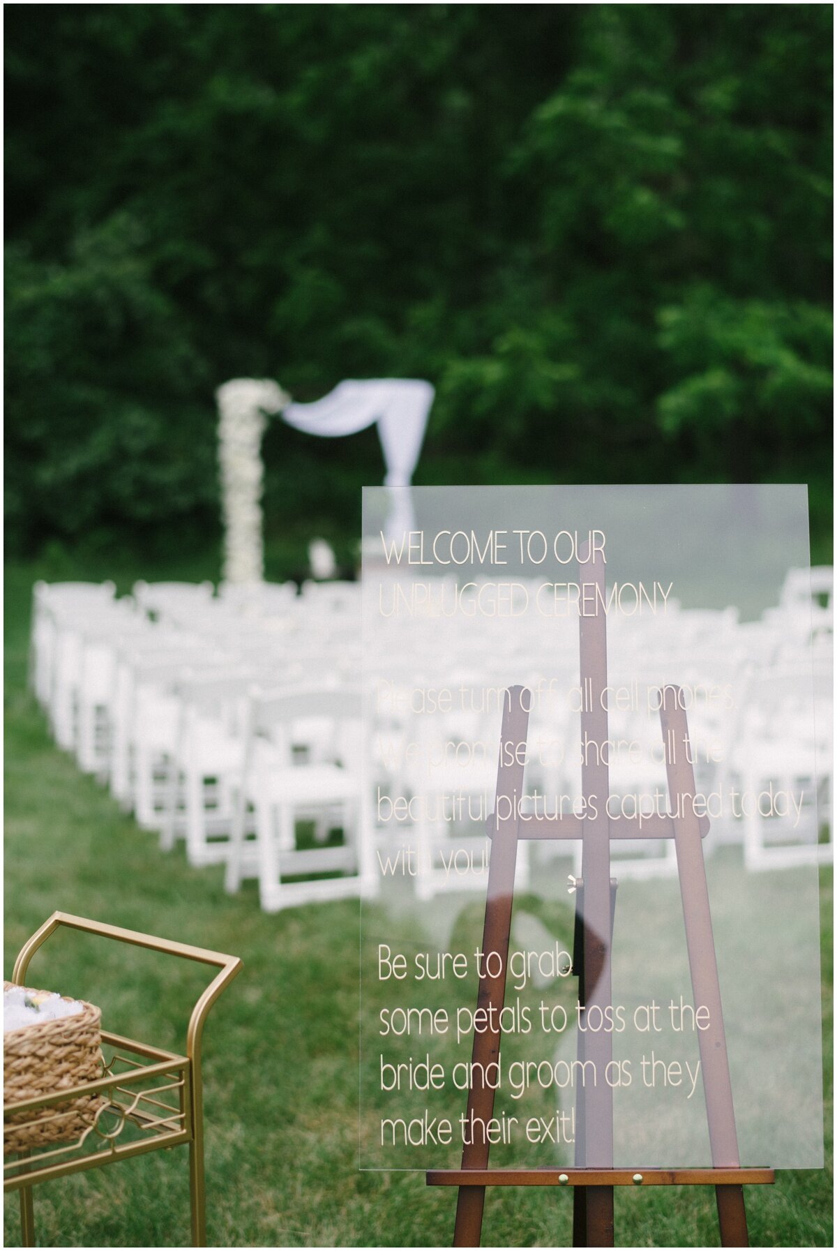  Outdoor wedding ceremony clear signage during private estate wedding 