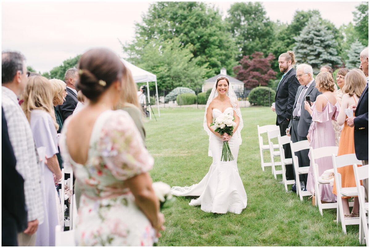  Bride walking solo down aisle during private estate wedding 