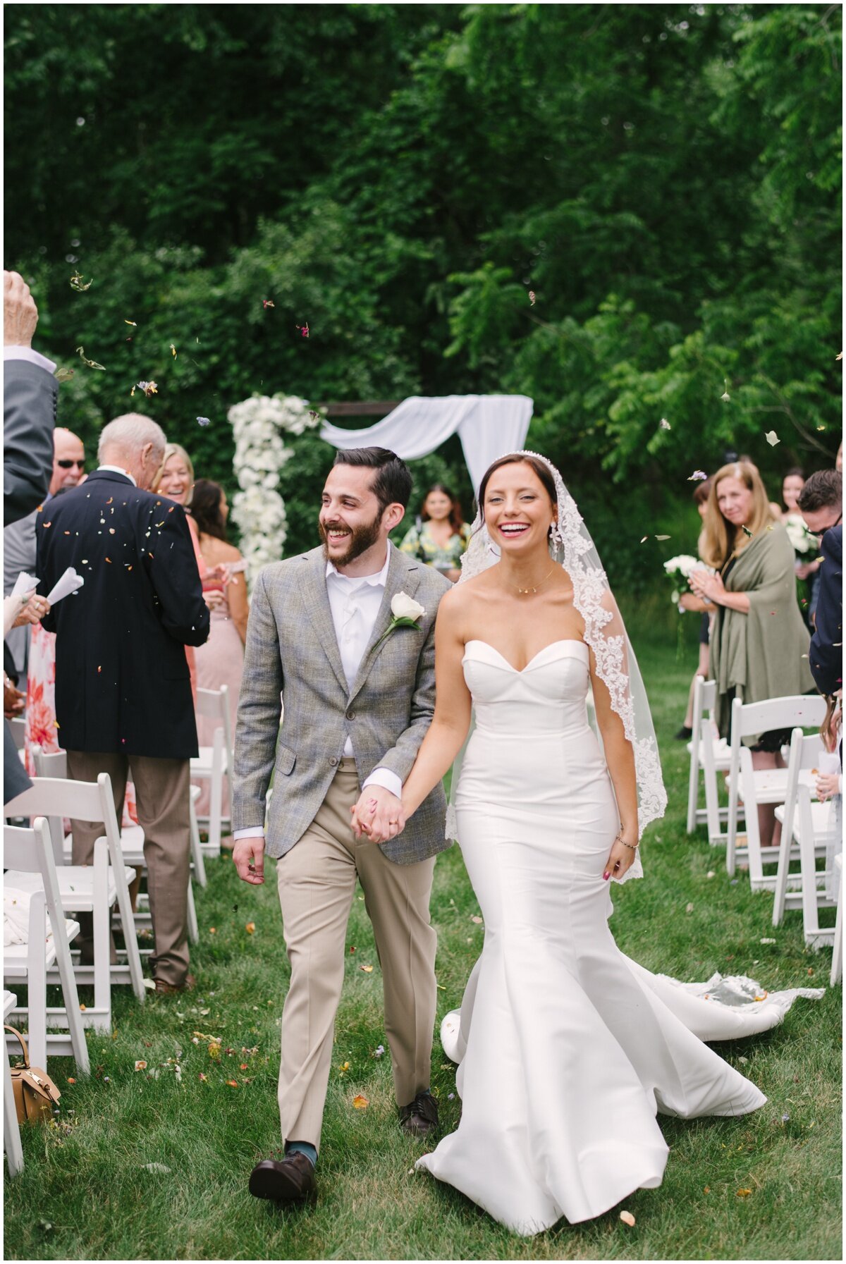  Newlyweds walking down aisle during private estate wedding 