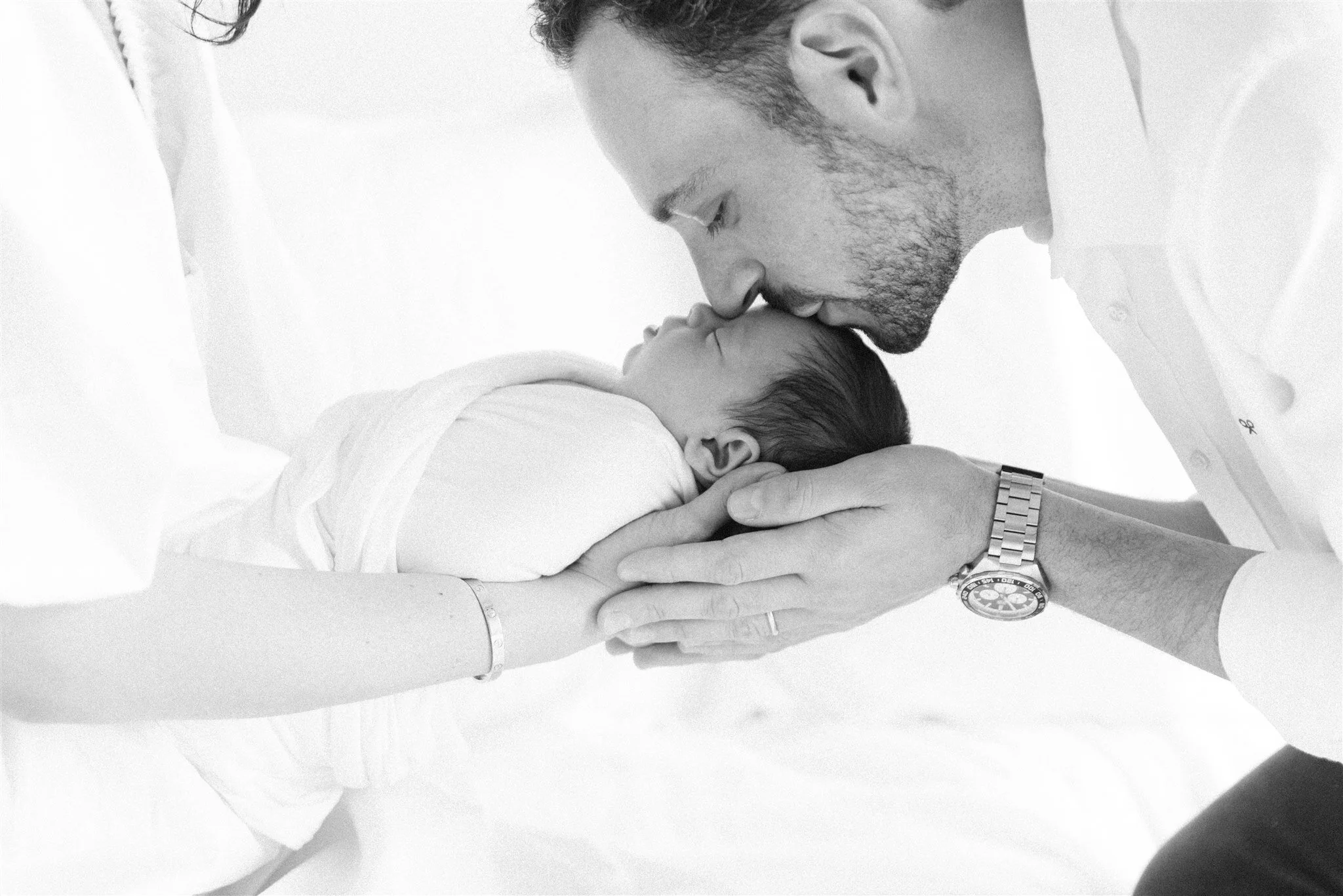 dad kissing his newborn during a lifestyle newborn session in Parkland FL