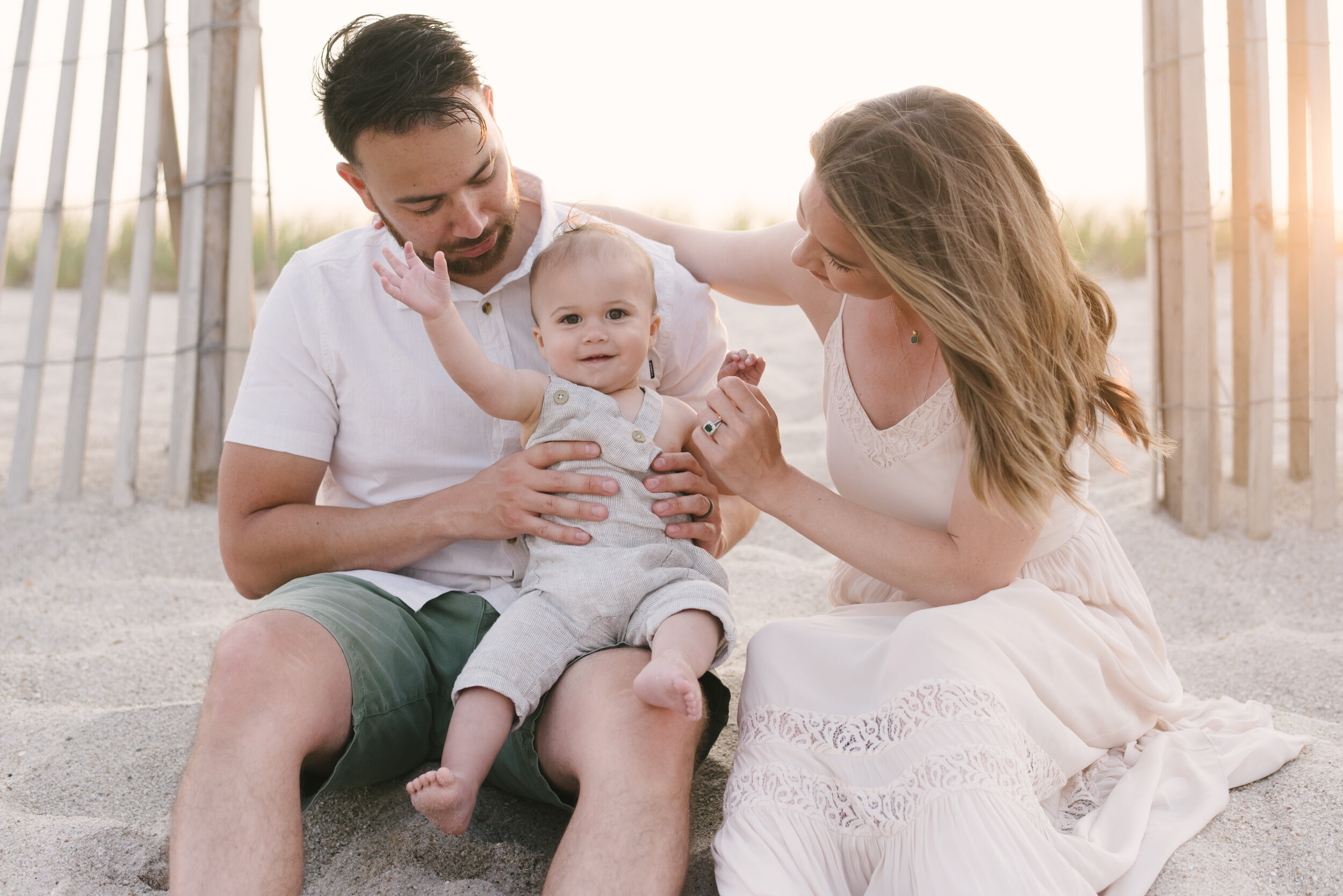 Beach photo ideas: Mom, dad, and baby in neutral colors on beach for family photos | NKB Photo