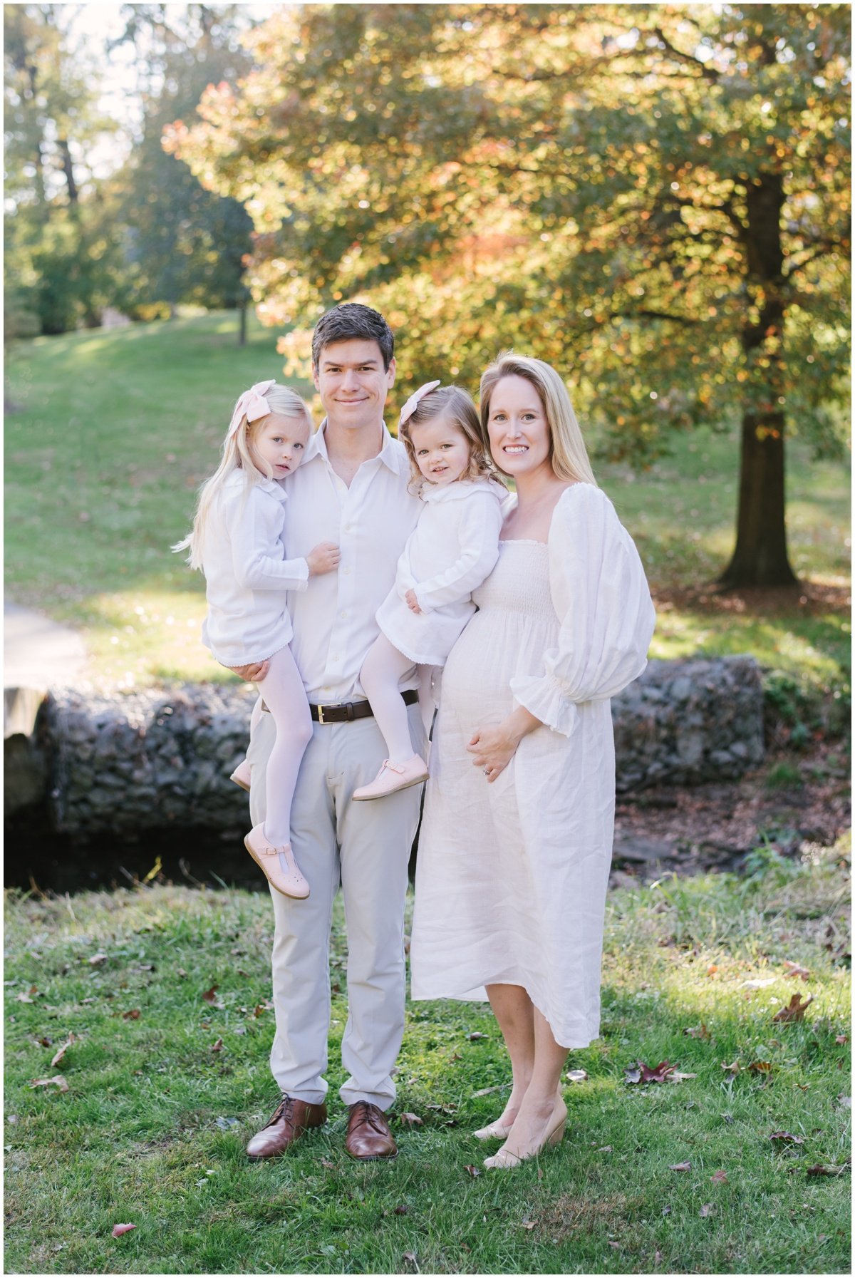 Mom, dad, and two daughters posing during fall family photoshoot | NKB Photo