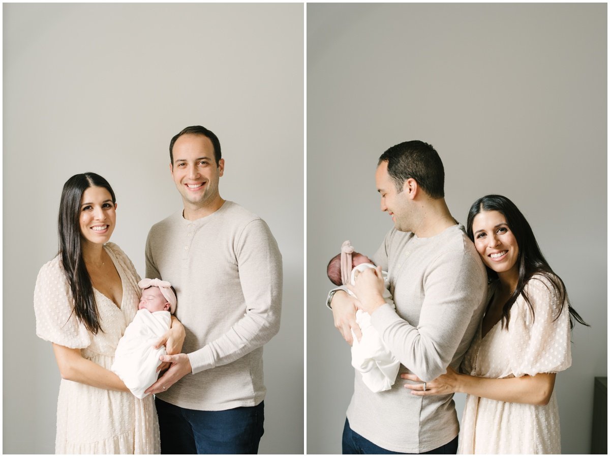 Mom and dad holding newborn baby girl during session with Jupiter photographer | NKB Photo