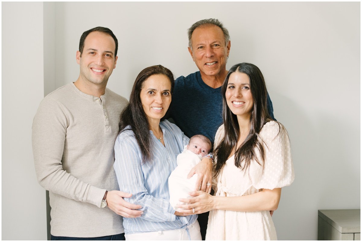 Mom and dad with grandparents who are holding newborn baby  during session with Jupiter photographer | NKB Photo