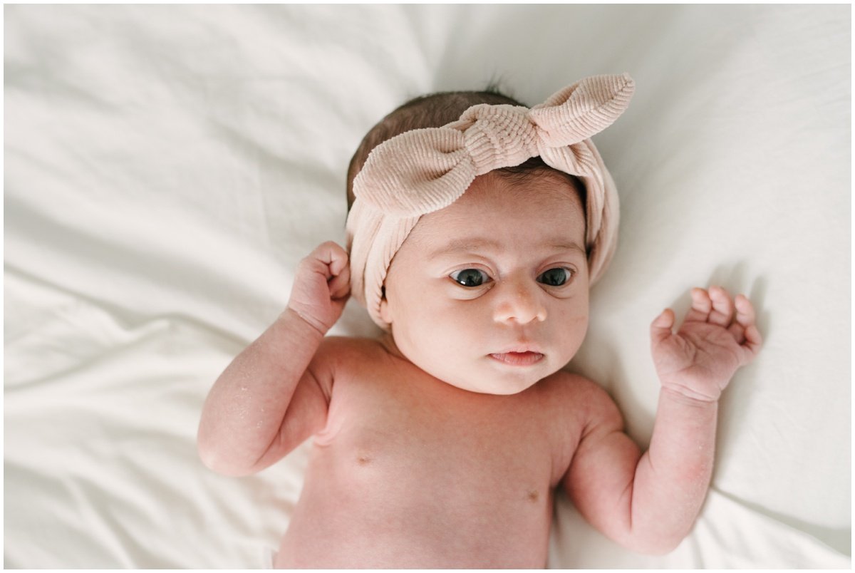 Newborn baby wearing corduroy bow  during session with Jupiter photographer | NKB Photo