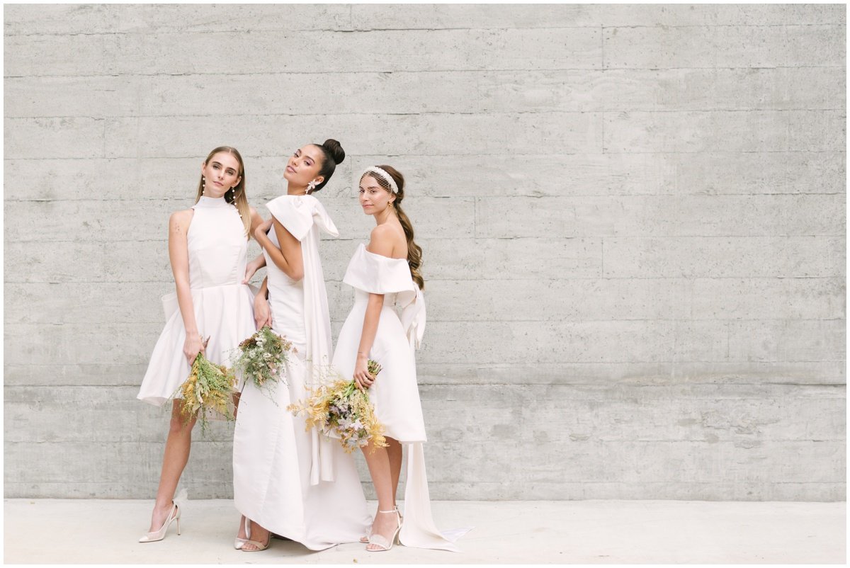 Three women in wedding dresses holding bouquets during styled shoot | NKB Photo