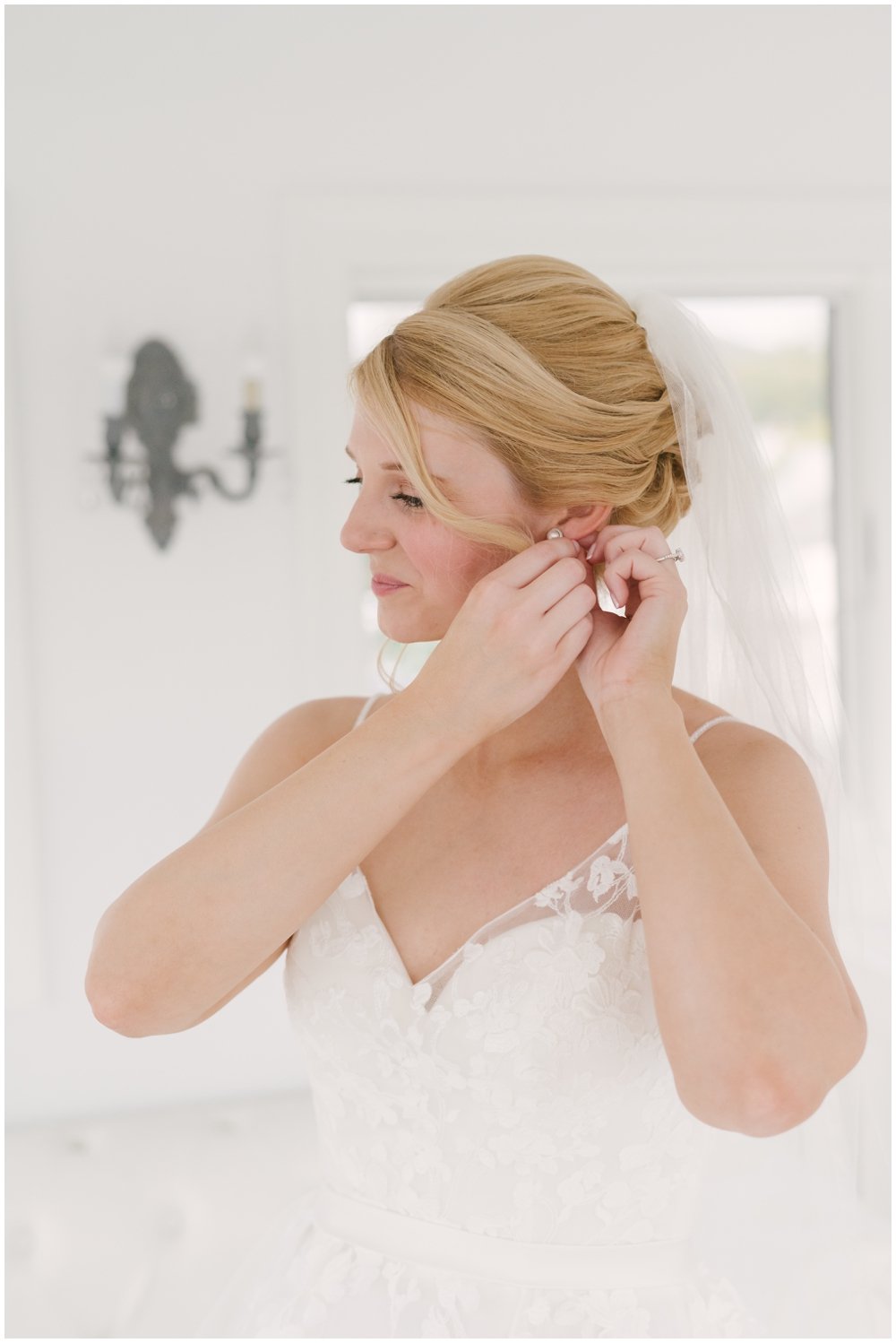 Bride putting on earrings before Lake Mohawk Country Club Wedding | NKB Photo