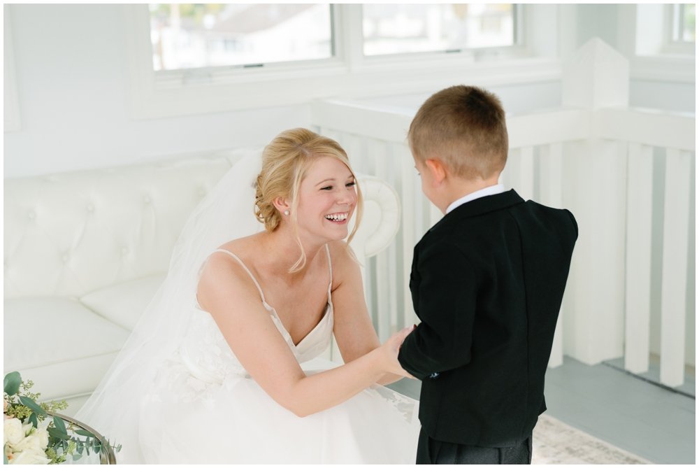 Bride talking to ring bearer before ceremony | NKB Photo