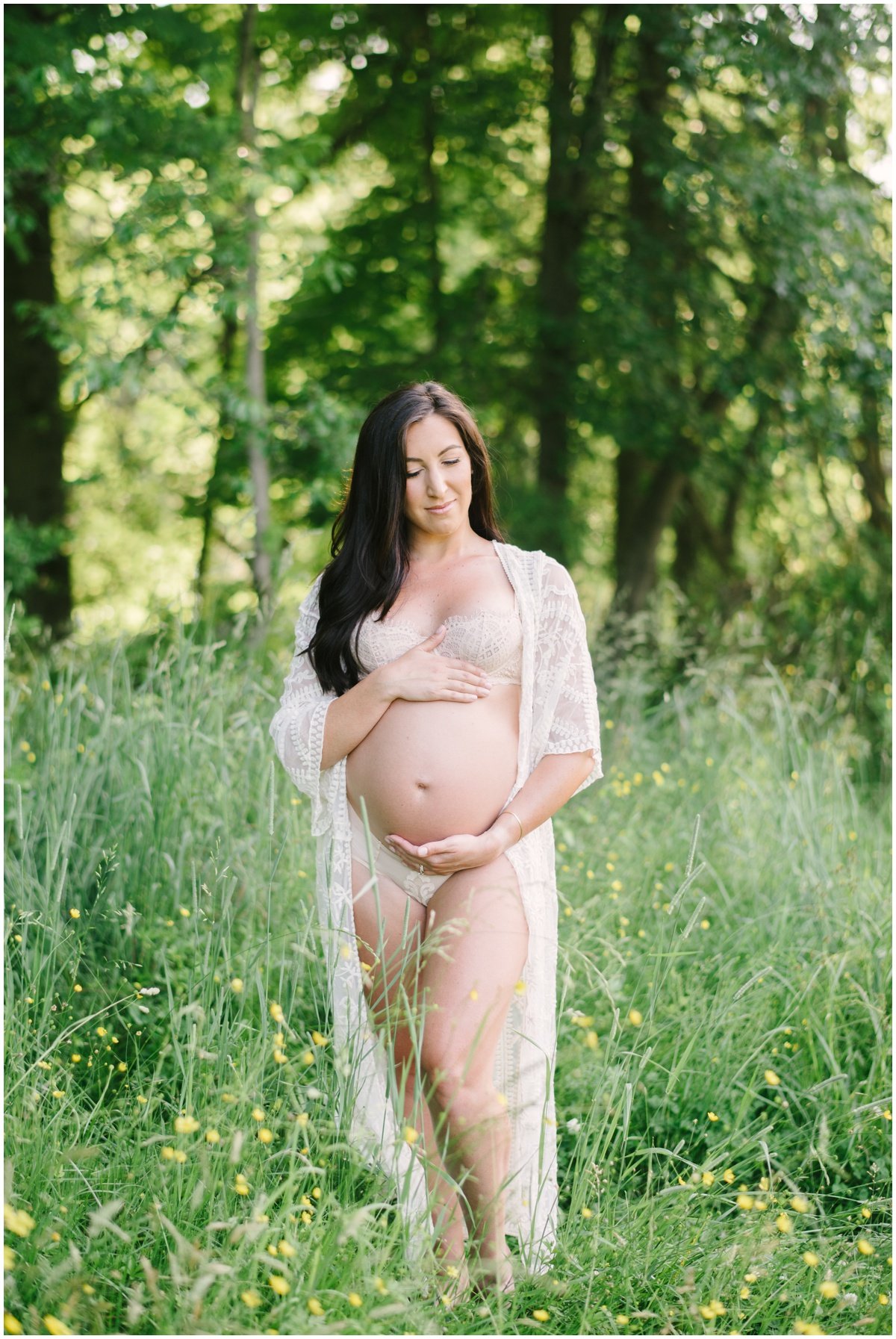 Woman cradling belly during maternity session | NKB Photo